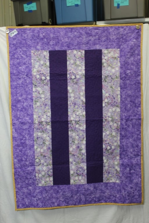 Project Linus Hand Made Quilt. Purples: Good overall as pictured. hunter green back. Measures about 56" x 82".
