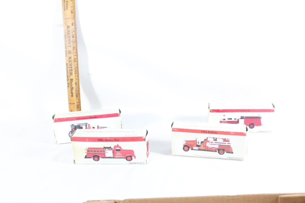 Four toy fire trucks in boxes (1 of 3)