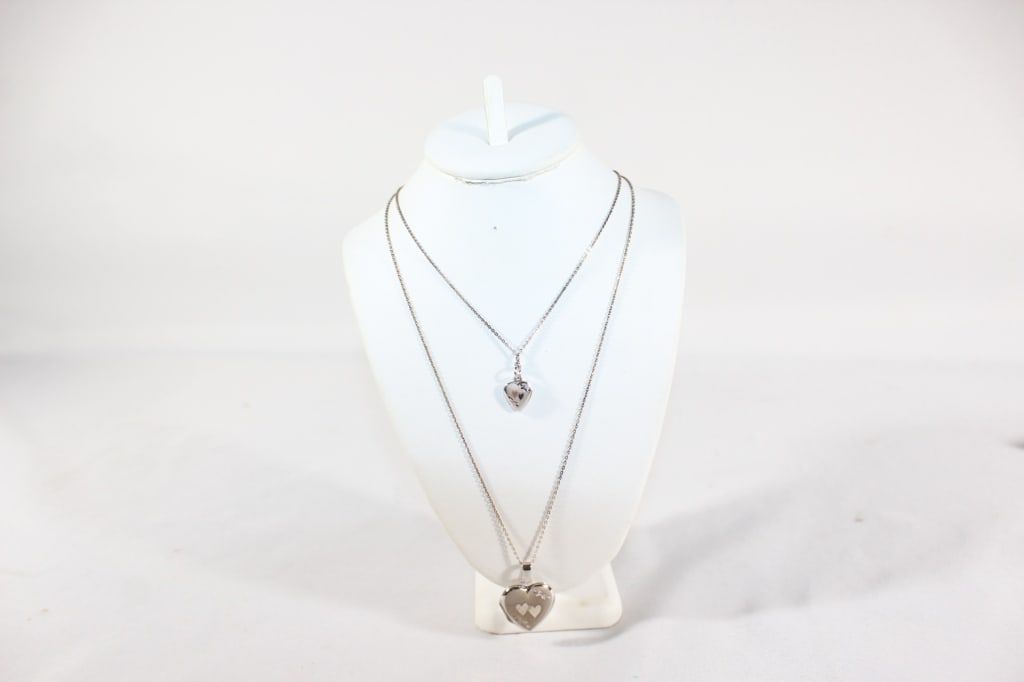 Pair of Sterling Silver Necklaces w Heart Lockets: Both Chains About 18n. / 0.223 ozt total *Proceeds from this lot benefit the Rotary Club of Greater Gainesville (Fla.)