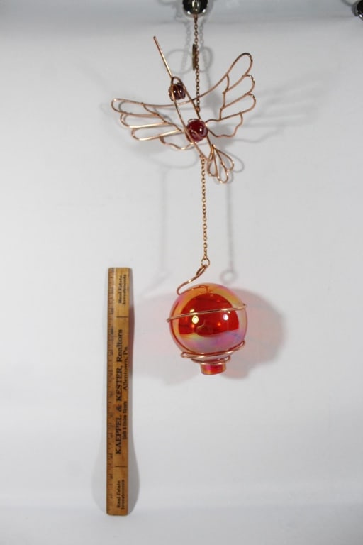 Copper colored hummingbird with globe: globe is glass and hummingbird is metal *Proceeds from this lot benefit the Rotary Club of Greater Gainesville (Fla.)