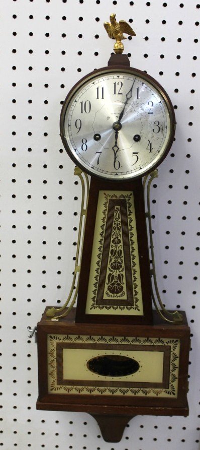 Seth Thomas Brooksfield Banjo Clock with Key: clock runs and chimes; minor wear to face clock as pictured; measures about 28 inches tall