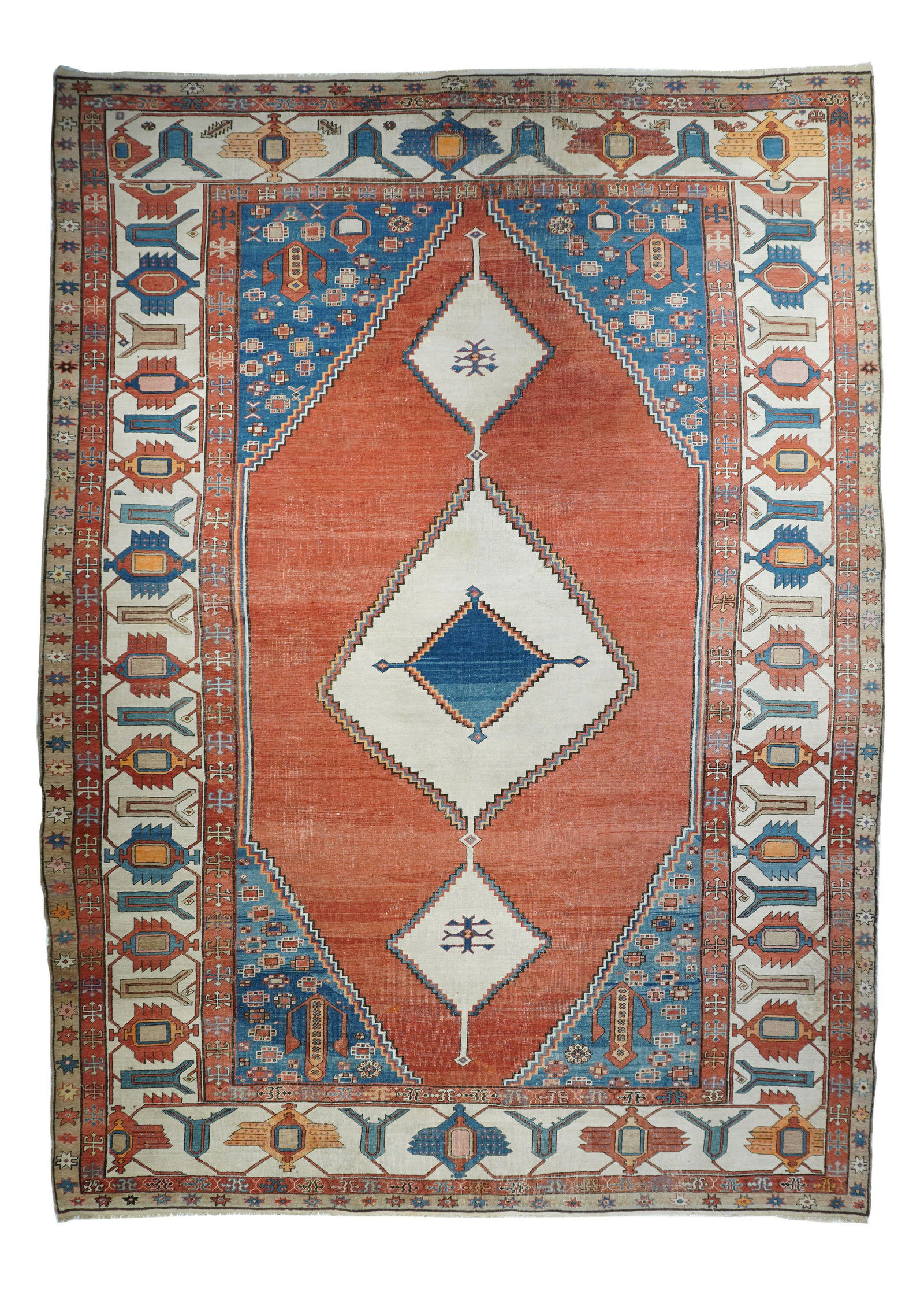 Antique Bakhshaish Rug, 10'4" X 14'11": From the “Caucasian” period of antique Heriz weavings, this looks like a giant Kazak in rust, abrashed light blue, abrashed medium blue, and ecru. A three diamond ecru pole medallion is se