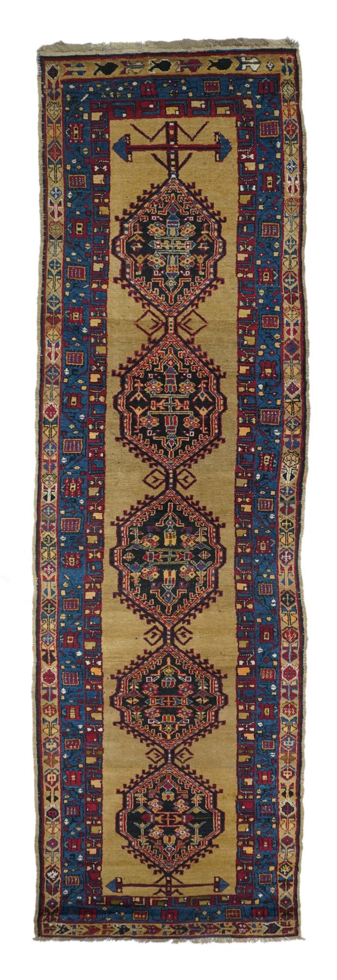 Antique Bakhshaish Rug, 3'6" x 14'3" ( 1.07 x 4.34 M ): The light golden camel open field displays a central pole medallion of five hook-fringed more-or-less hexagonal medallions in near black, medium blue, ecru and straw. Main medium blue border with a me