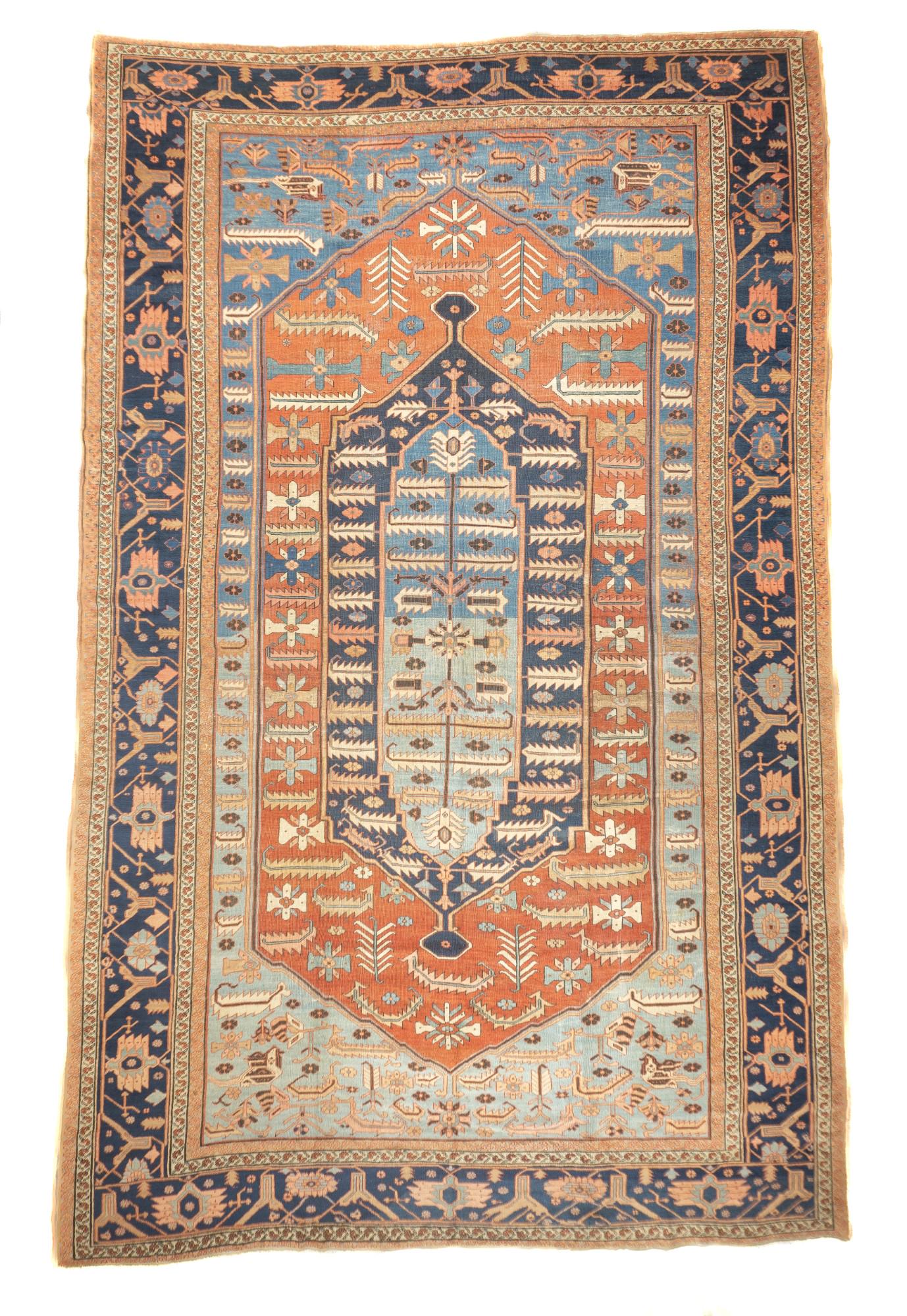 Antique Bakhshaish Rug, 11'5" x 18'3" (3.48 x 5.56 M): The field abrashes from powder to light blue, and shows a tall red hexagonal panel decorated with rosettes and barbed straight leaves, enclosing concentric navy and light blue-powder medallions, with
