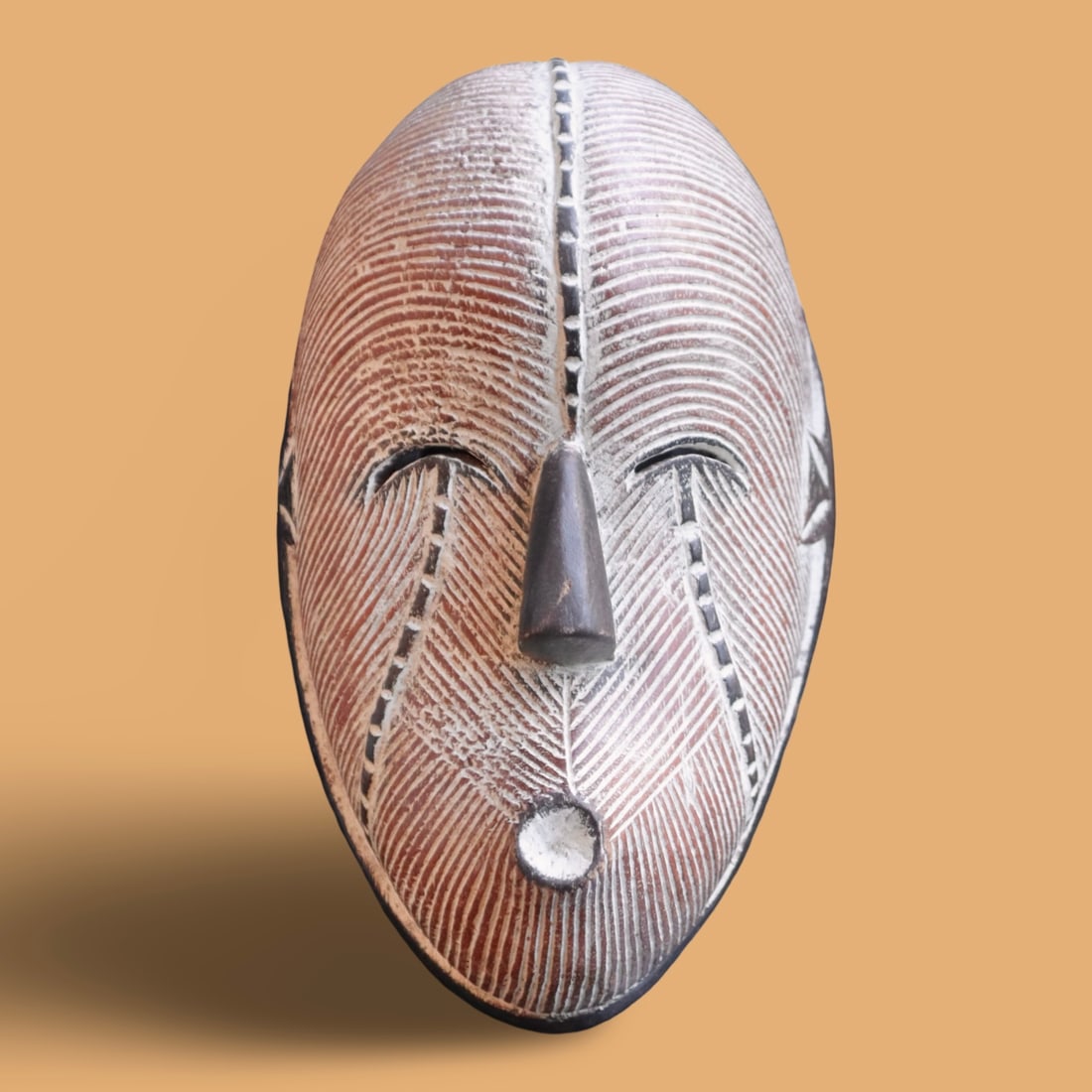 Songye Kifwebe Mask: This image shows a Songye Kifwebe mask, which is a traditional collectible art form from the Democratic Republic of the Congo. Type: These masks are carved by the Songye and Luba peoples and represent