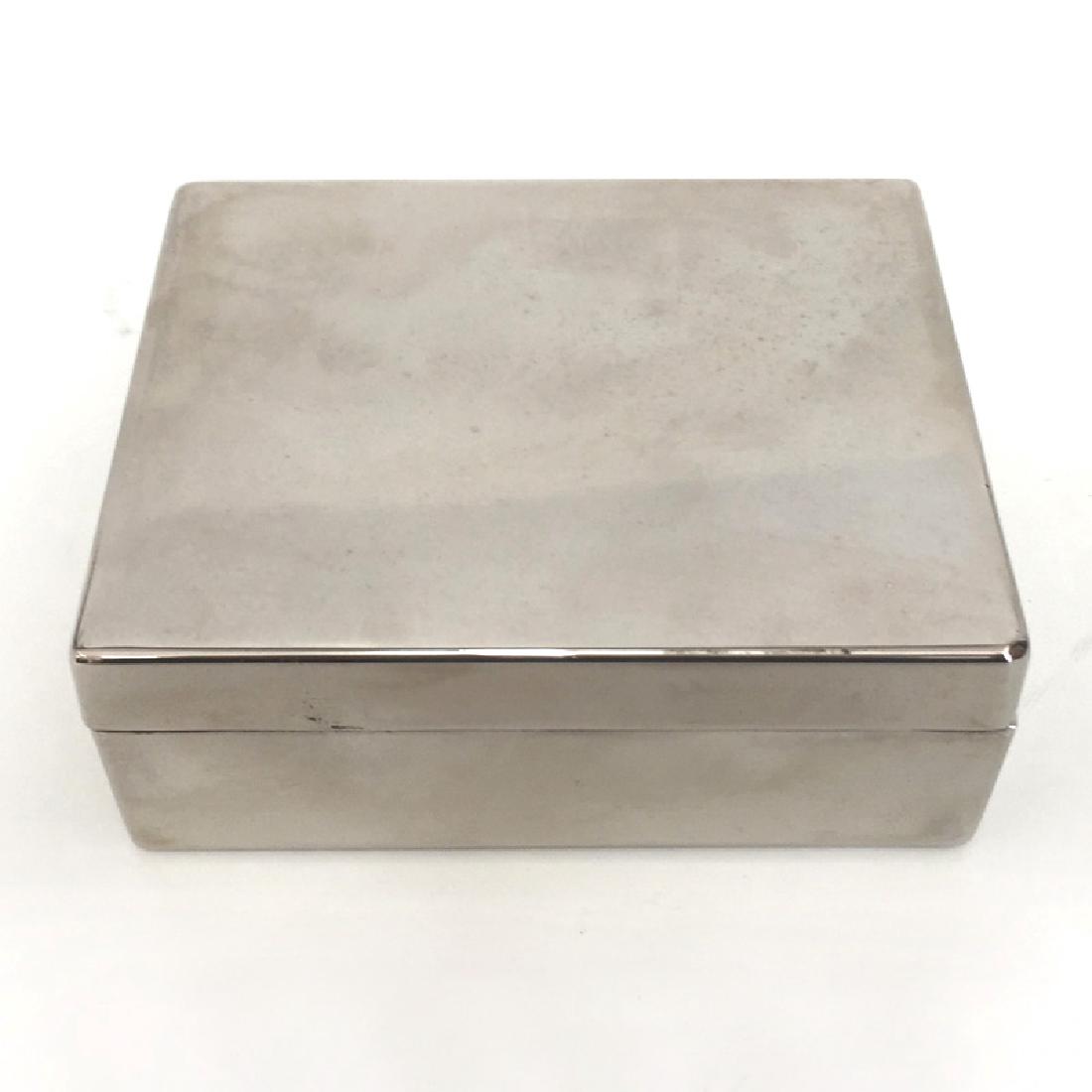 Silver tone metal rectangular box for fragrance and: Silver tone metal rectangular box for fragrance and white velvet from inside made by DKNY. Box is empty. Measured 4" x 3 1/4" x 1 1/2". Condition very good.