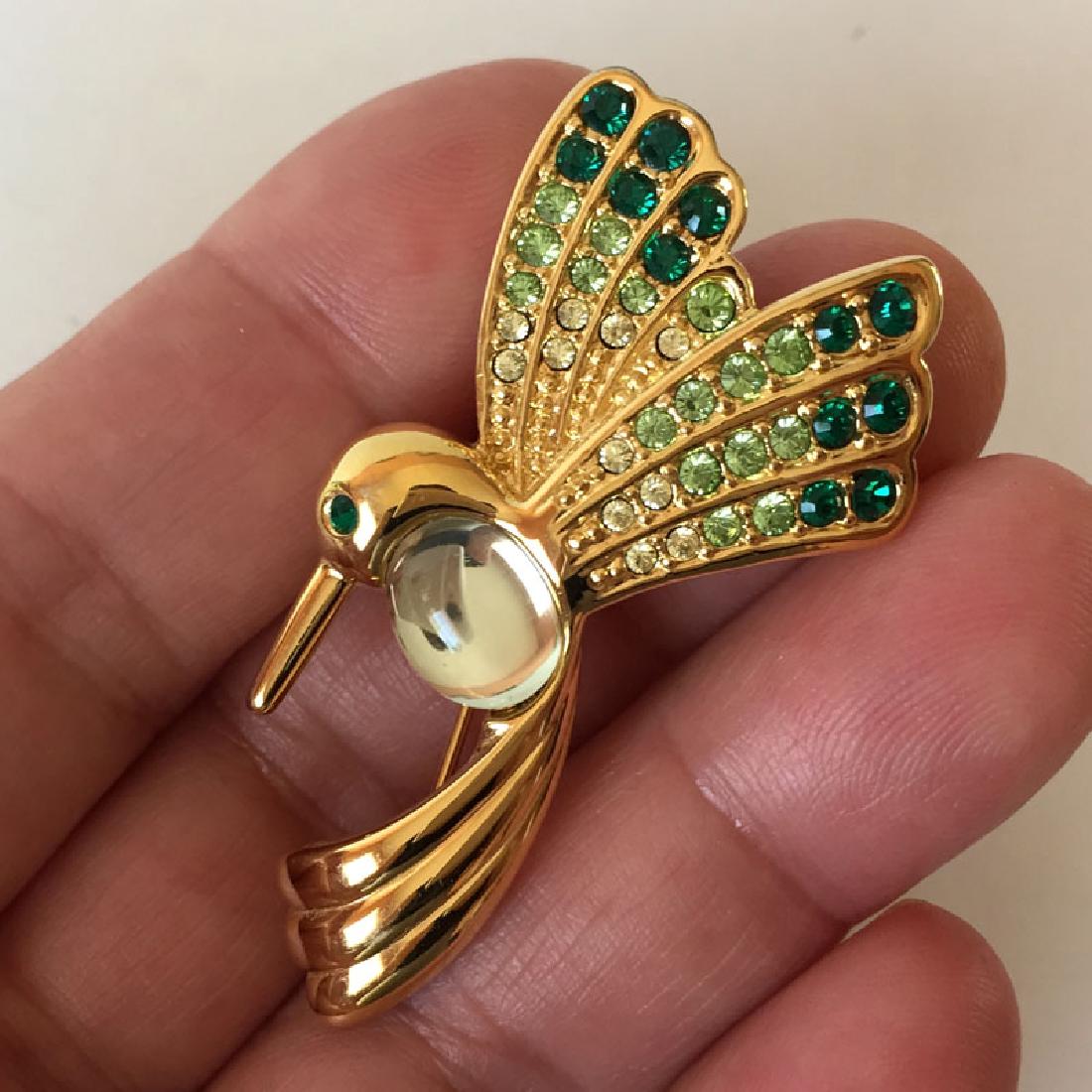 MONET: Gold plated BIRD shaped brooch with rhinestones,: MONET: Gold plated BIRD shaped brooch with rhinestones, signed. Length 2". Condition excellent.