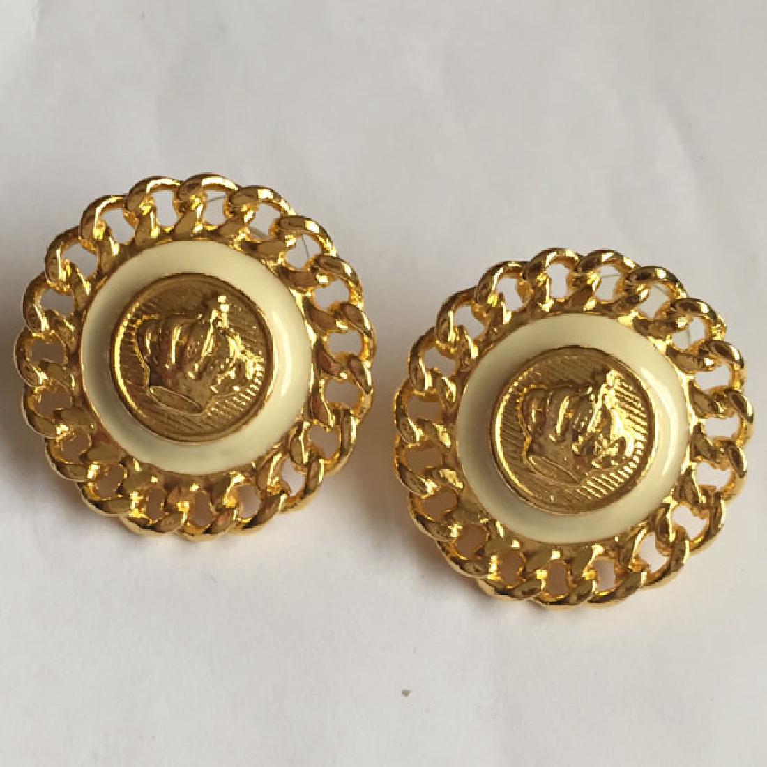 Gold tone and white enamel big round shape push backs: Gold tone and white enamel big round shape push backs earrings with crown in the center and Cuban link chain design all around. Measured 1" in diameter. Condition excellent.