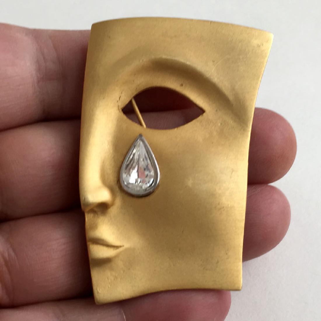 Gold plated satin finish ABSTRACT FACE with tear drop: Gold plated satin finish ABSTRACT FACE with tear drop crystal set in silver tone bezel. Measured 2 1/4" x 1 1/2". Condition excellent.