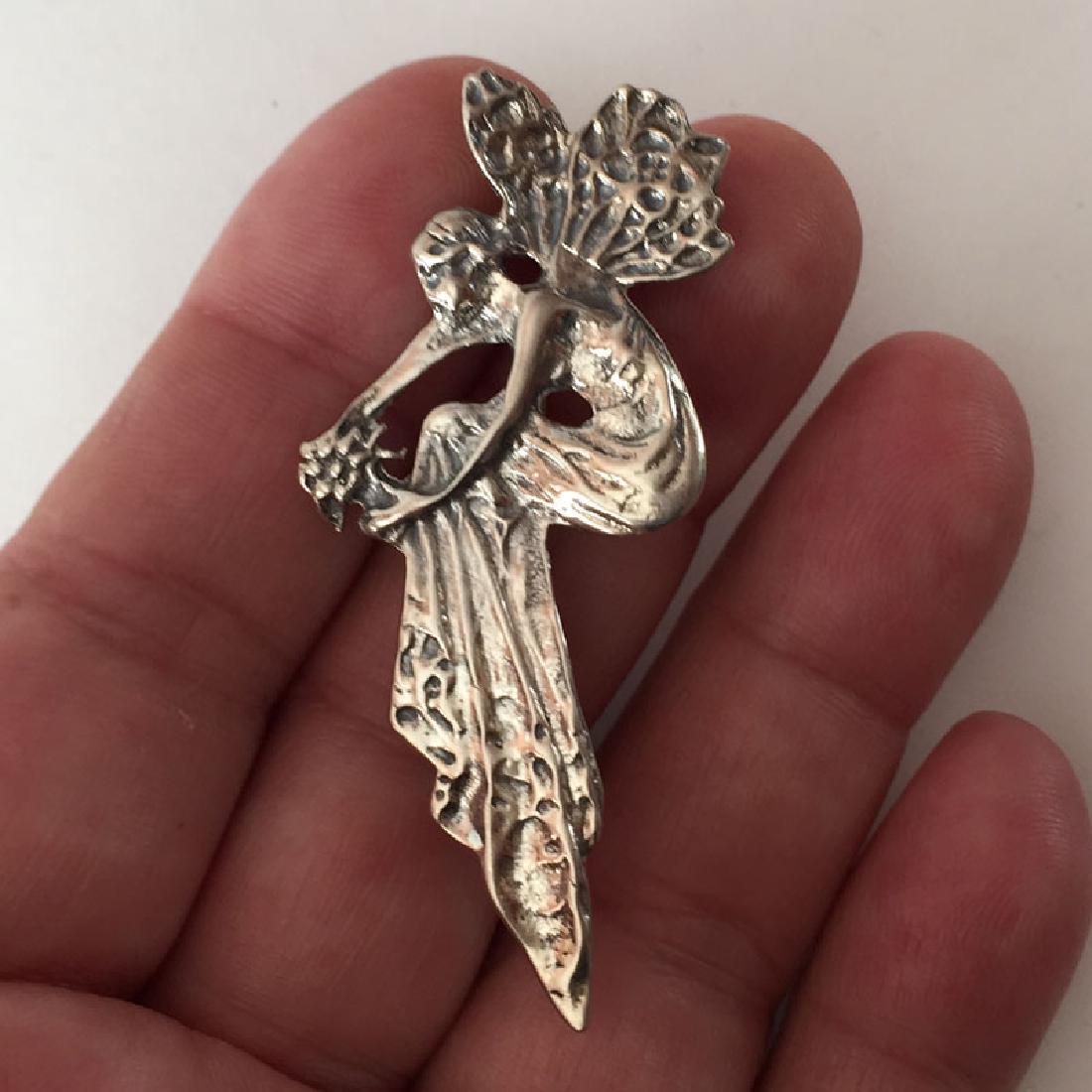 LLC: Sterling silver FAIRY WITH BUQUET shaped brooch,: LLC: Sterling silver FAIRY WITH BUQUET shaped brooch, signed. Weight 8.2 grams. Hallmarked 925. Length 2 1/4". Condition very good.