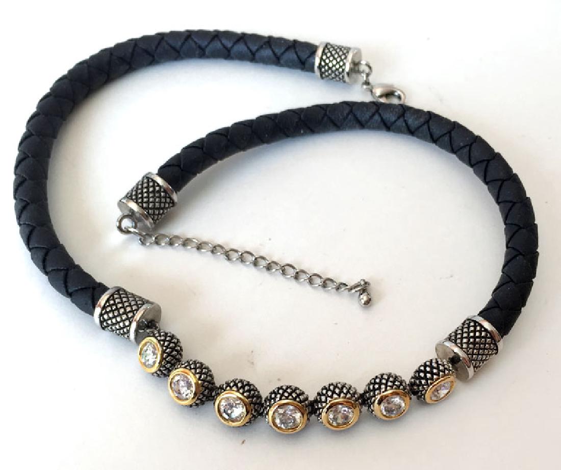 Braided black leather strand with silver tone lobster: Braided black leather strand with silver tone lobster clasp, end cups, chain and set in gold plated bezel white CZs necklace. Leather part measured 7 mm in diameter. Length 16" plus 3" extension. Cond