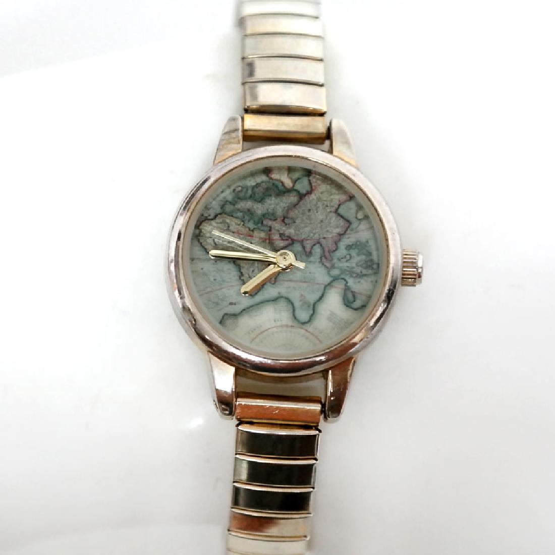 Vintage gold plated round ladies watch with stretchable: Vintage gold plated round ladies watch with stretchable bracelet. Dial with world map, no numbers. Case measured 22 mm in diameter. Stainless steel back. Bracelet is new, excellent condition. Conditio