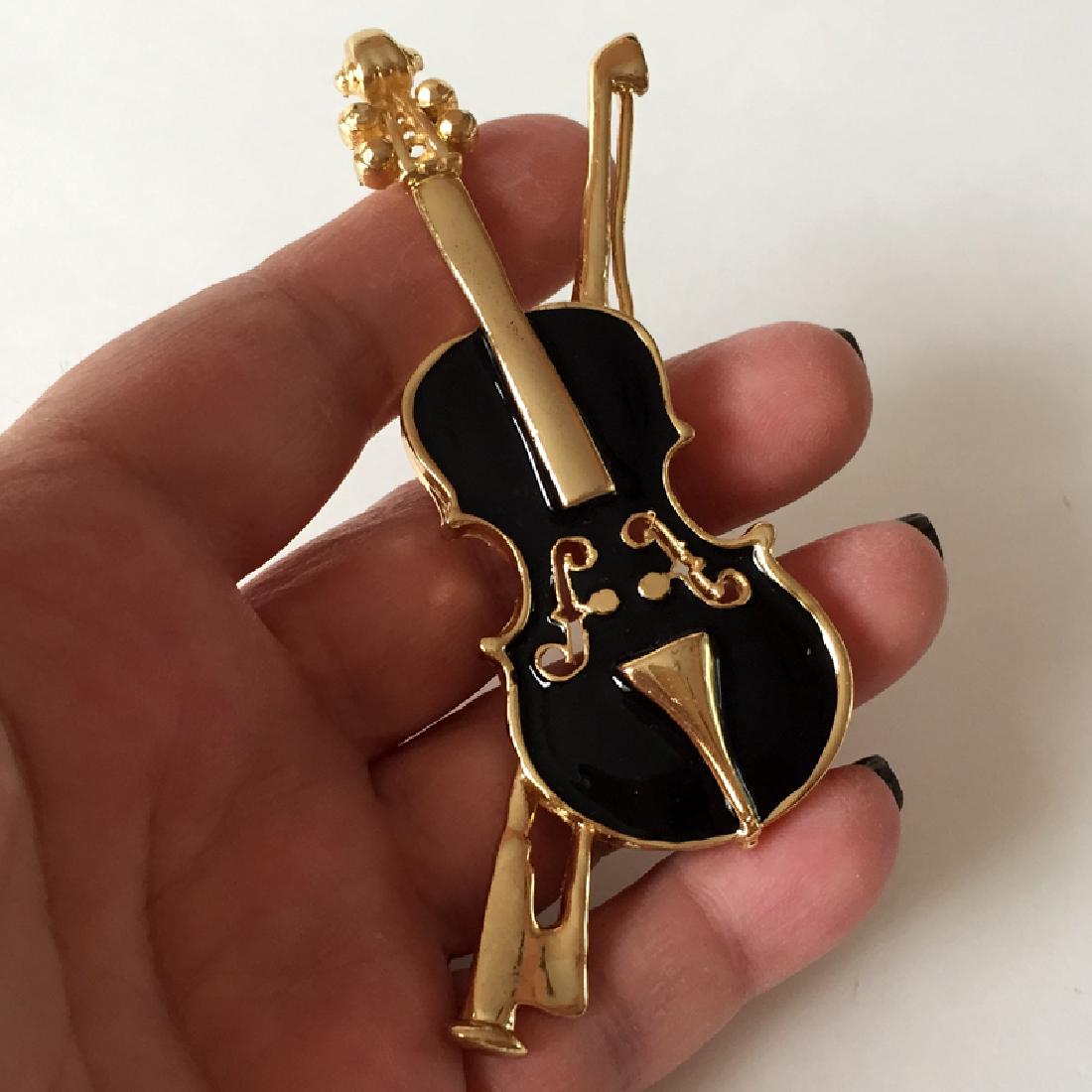 Gold plated VIOLIN shaped brooch with black enamel: Gold plated VIOLIN shaped brooch with black enamel. Length 3 3/4". Condition excellent.