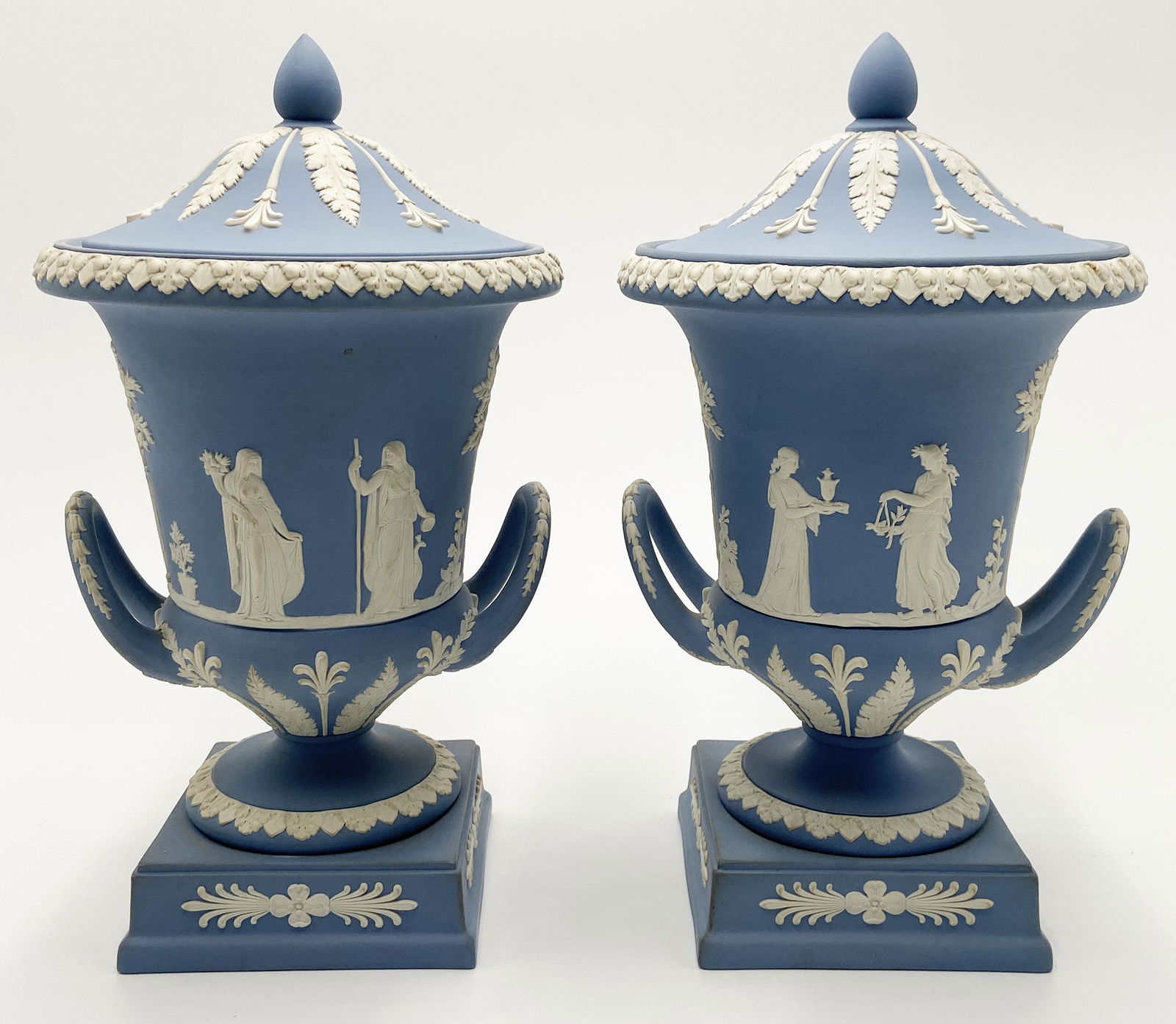 Pr. of Blue Wedgwood Jasperware Urns.: In the Original Boxes. The boxes have a little wear to them. The urns measure 12" tall. They could use a little old-fashioned soap and water.