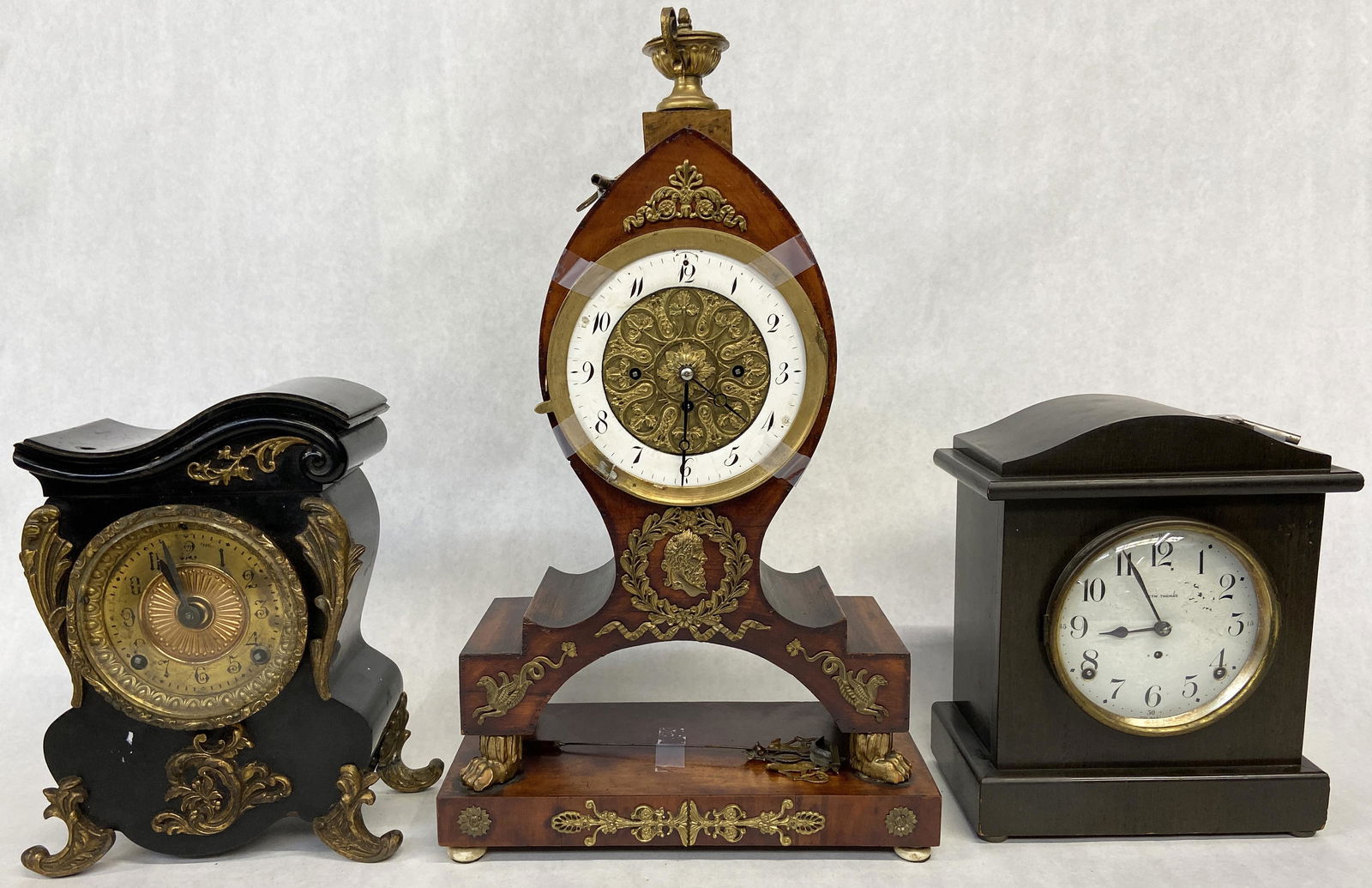 Lot of 3 Antique Clocks.: One smaller one is Seth Thomas (It Runs). The other smaller one in the black and gold case is Ansonia (Does not run). The ansonia clock has a hole in the top of it for some piece of ornamention that i