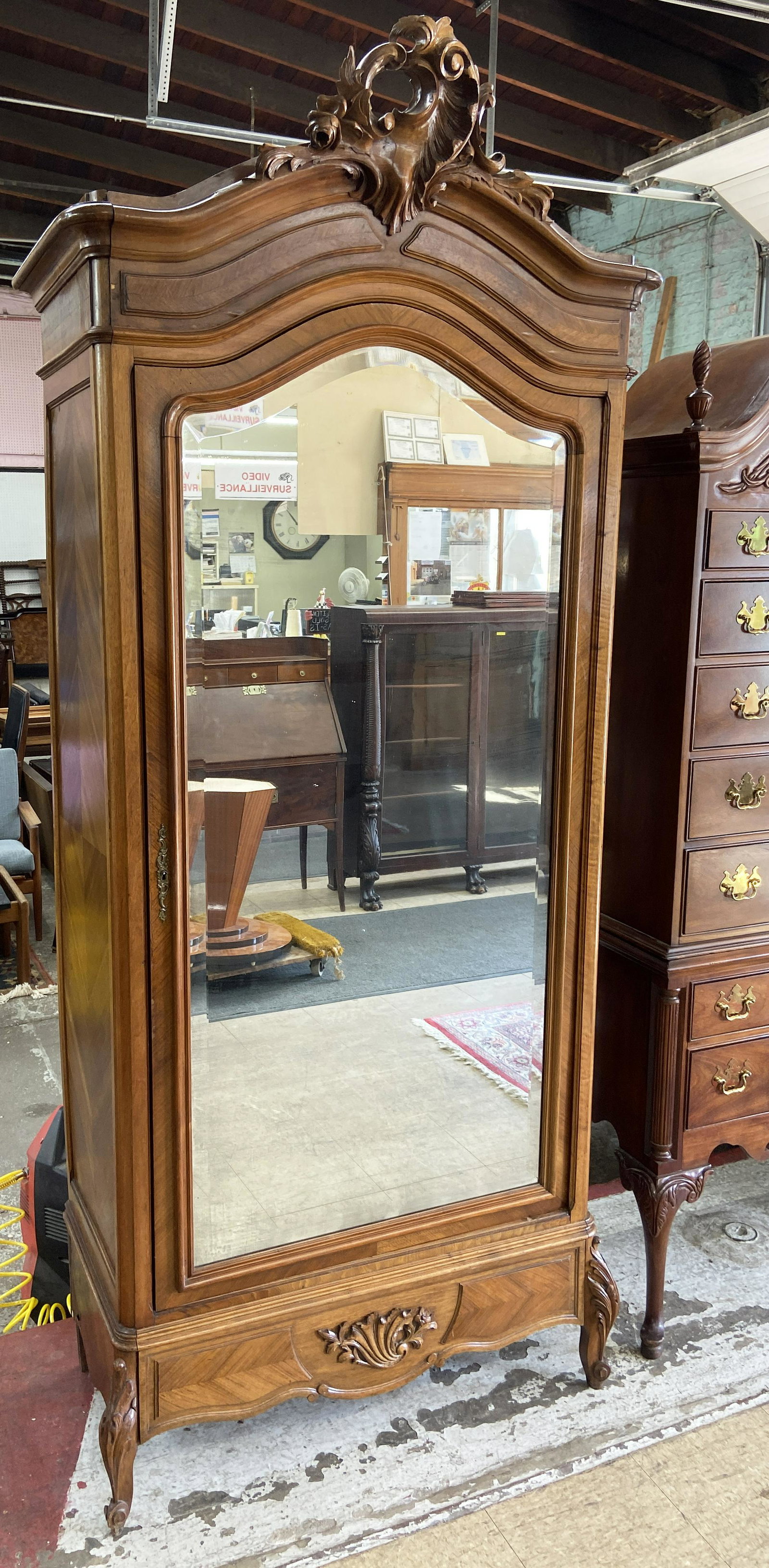 French Carved Armoire with Bevelled Mirror Front.: Has minor veneer damage to the front. Has fairly extensive veneer damage to the left hand side and leg area (see Photo). Measures 93" Tall, 36" Wide, and 17 1/2" Deep.
