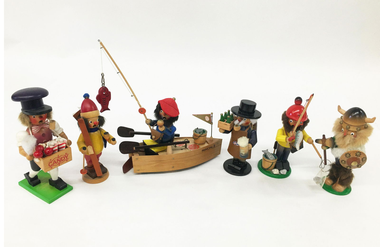 Lot of 6 Carved Wood German Smokers: Vintage, in good condition. Includes a Steinbach fishing boat music box. Boat is 13 inches long. Tallest smoker is 12 inches tall.