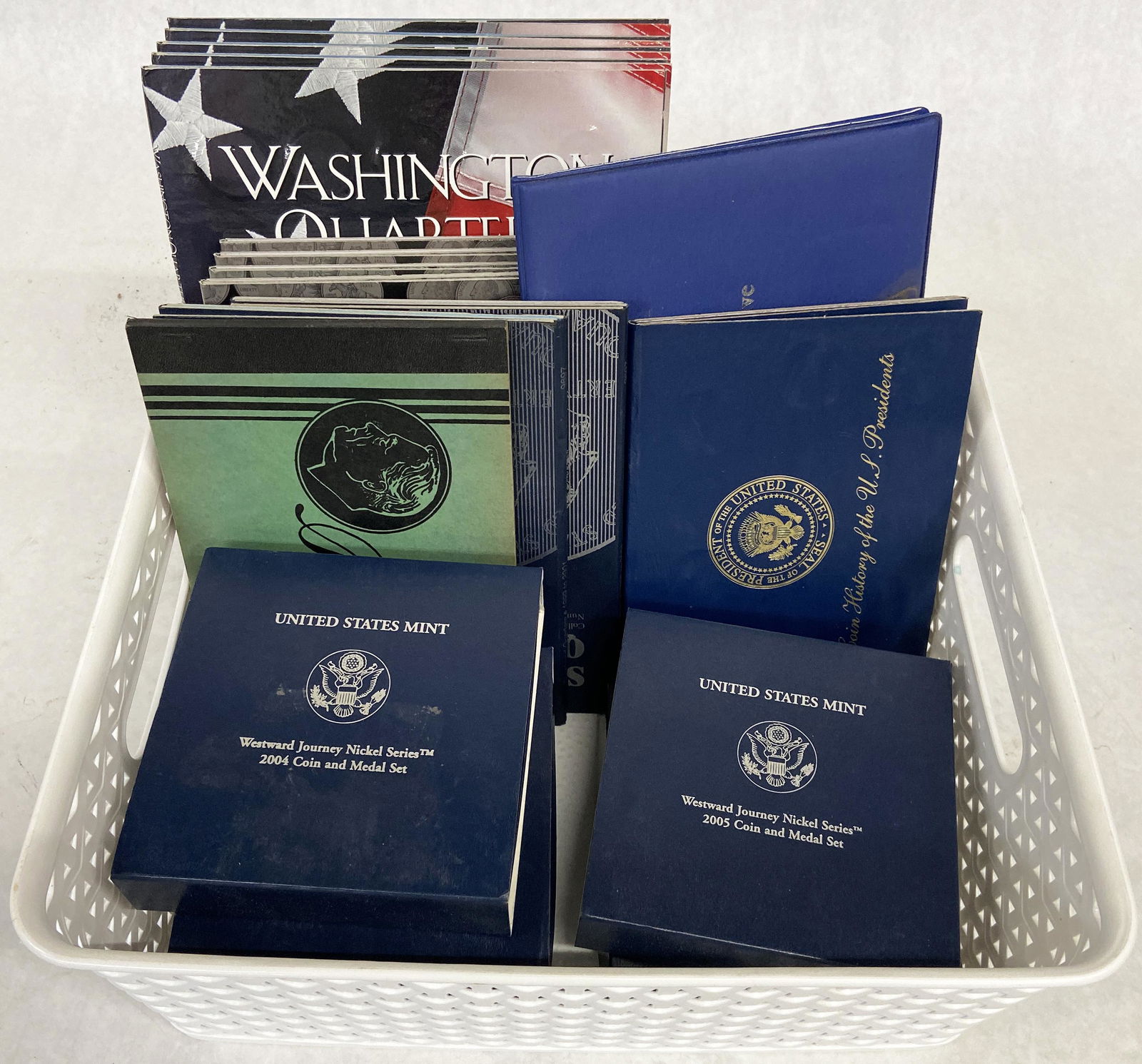 Bin of Assorted Coin Sets.: 5 Westward Journey Nickel Sets (2004 & 2005), 10K Space Shuttle Gold Piece, Five 1999-2003 State Quarter Collections (Vol. I), Four 1999-2003 State Quarter Collections (Vol. I), 2 Empty Statehood Quar