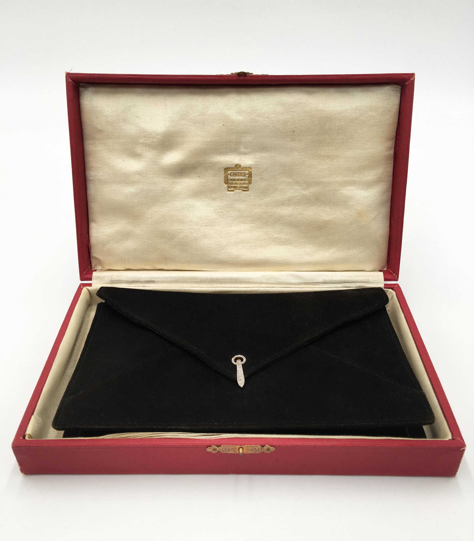 Cartier Clutch Handbag w/ Diamond Clasp.: Circa 1930's. Has a compact purse and coin purse inside. The Bag Measures 8" x 5" x 1". Aside from a bit of Lint, it seems to be in Excellent Condition - Perhaps it was never used. The Gold Cartier Em