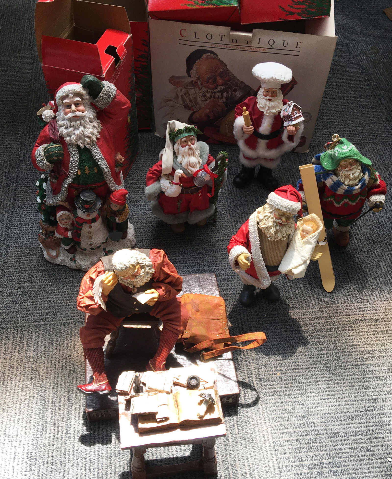 Lot of Santa Claus Figurines.: 4 Clothtique figurines, a large resin sculpture, and a Norman Rockwell Saturday Evening Post Statue.