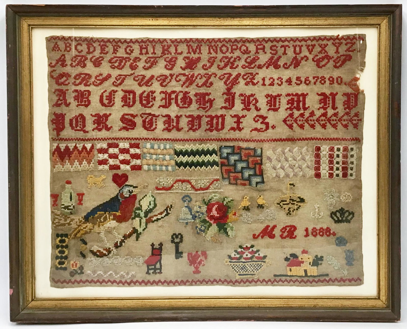 Colorful Needlepoint Sampler Dated 1888.: Signed "M.R.". Framed. In Good Condtion, but has a Small Portion Eaten Away on the Upper Right. Measures 13 1/2" x 17". We will Ship only if we don't have to ship the frame and/or Glass. Otherwise, Th