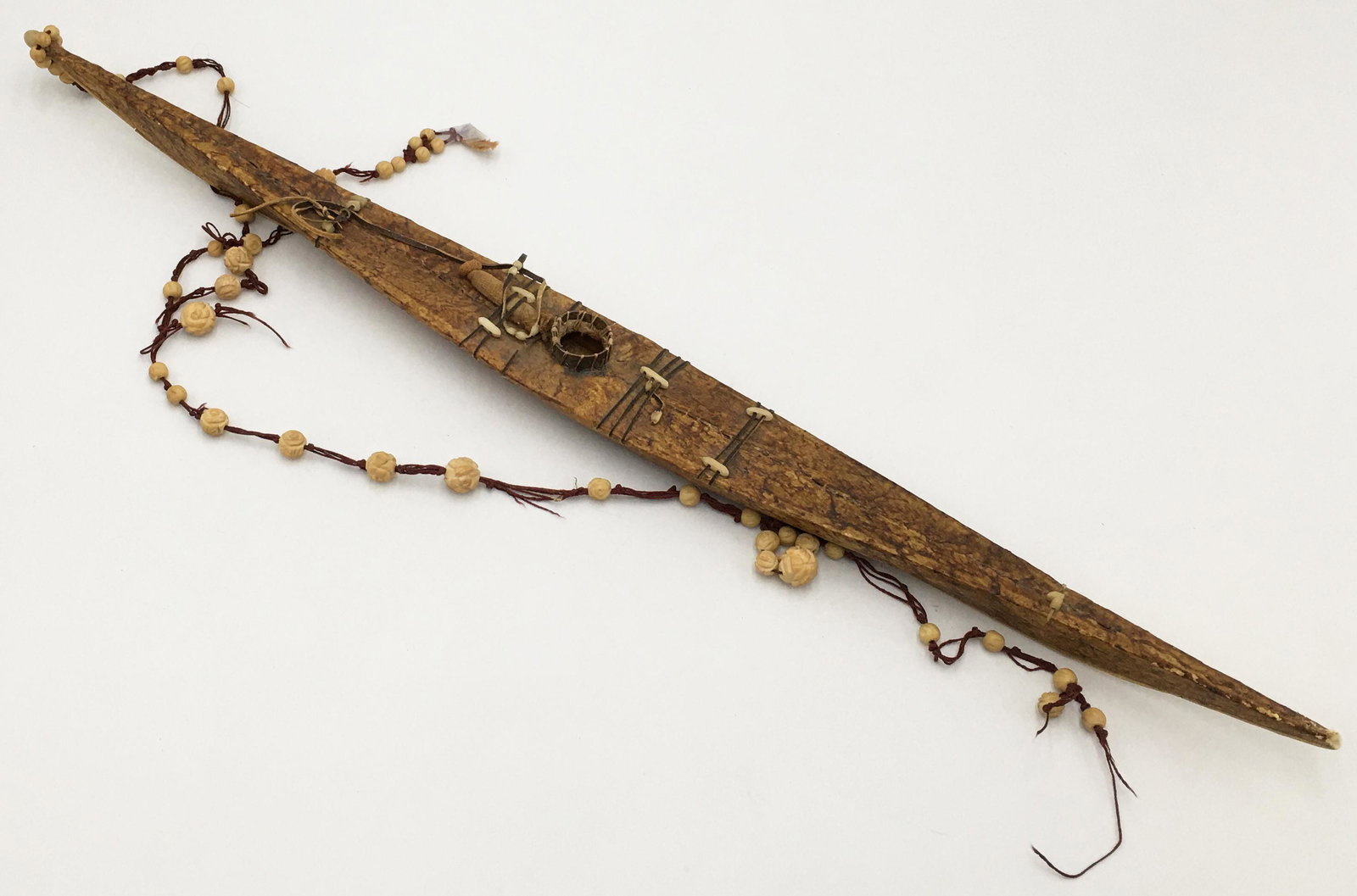 1940's Inuit Eskimo Sealskin Kayak.: With Carved Bead String. Kayak Measures 21 1/2" Long. Due to the Fragile Nature of this Piece, Third-Party Shipping is Required.
