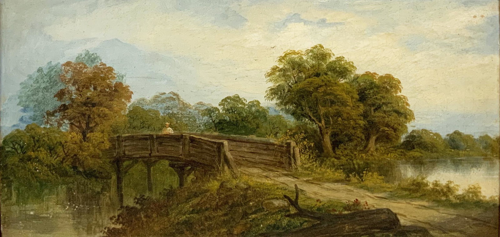 British School 19th Century Oil on Canvas Painting: Of a Figure on a Bridge in a River Landscape. Unsigned. Measures 12" x 24". Third-Party Shipping Required.