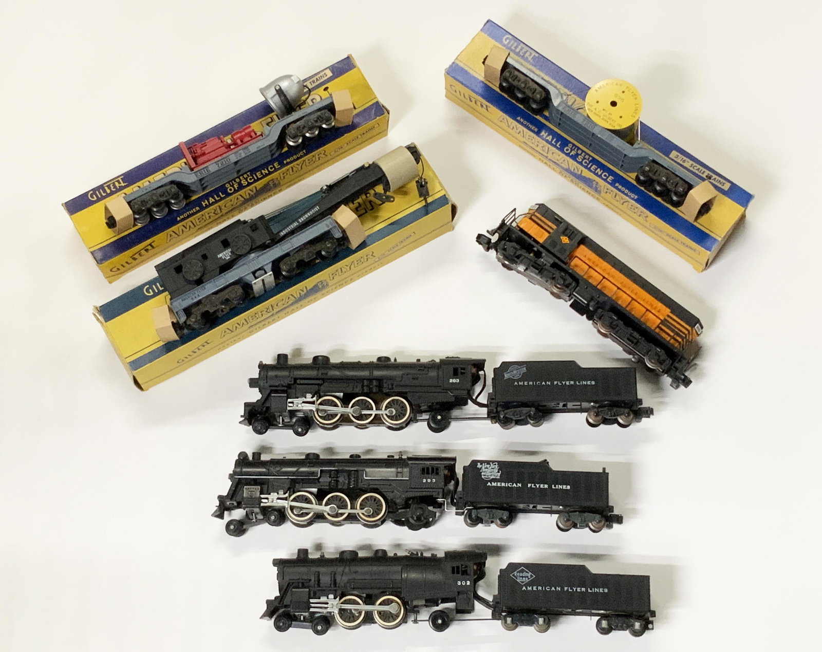 Lot of American Flyer Engines & Train Cars.: Includes: Engine #293 with Tender, Engine #283 with Tender, Engine #302 with Tender, #940 Floodlight Car w/Original Box, #936 Depressed Center Car w/Original Box, #944 Crane Car w/Original Box, and #3