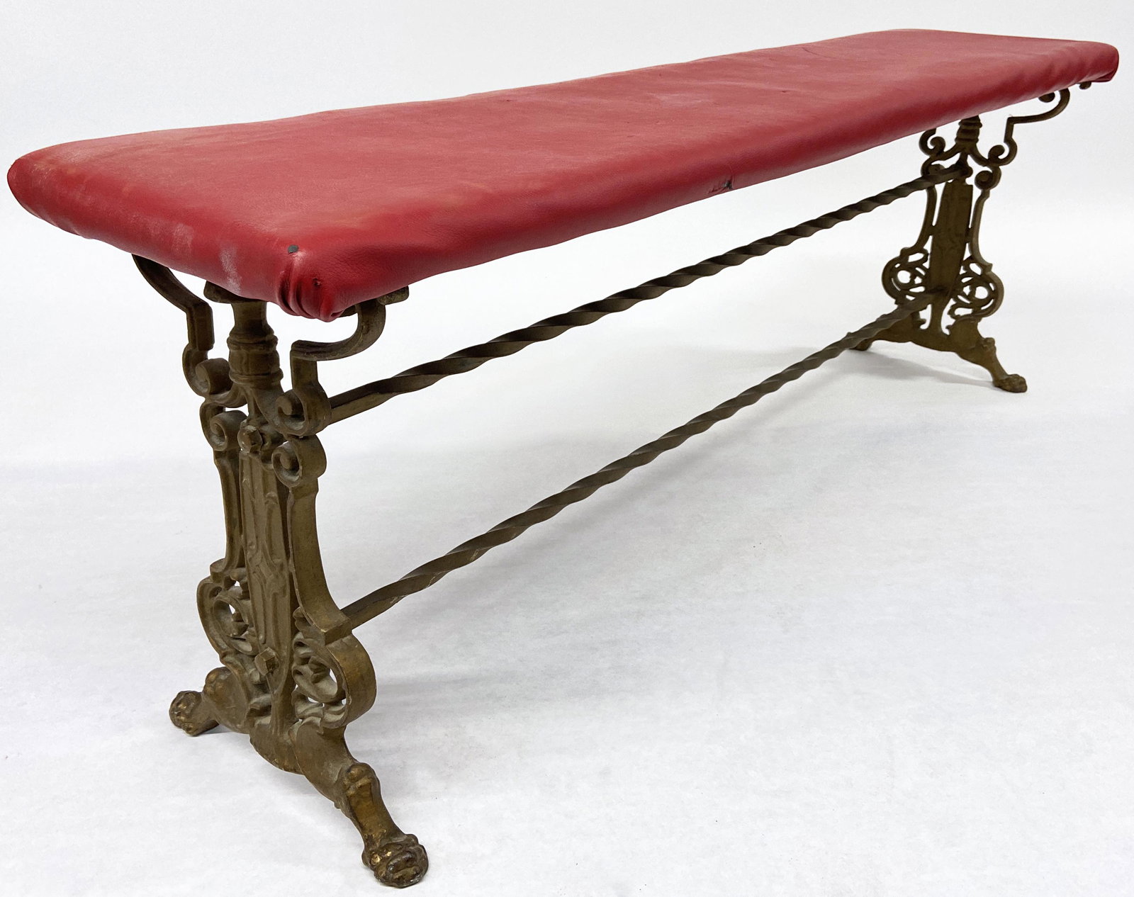 Wrought Iron Bench with Red Vinyl Top.: The Top has some Tiny Holes and Divots in it. The Bench is Painted a Bronze Color. Bench Measures 11 3/4" Wide, 47" Long, and 17 1/2" High. Third-Party Shipping or Personal Pickup Required.