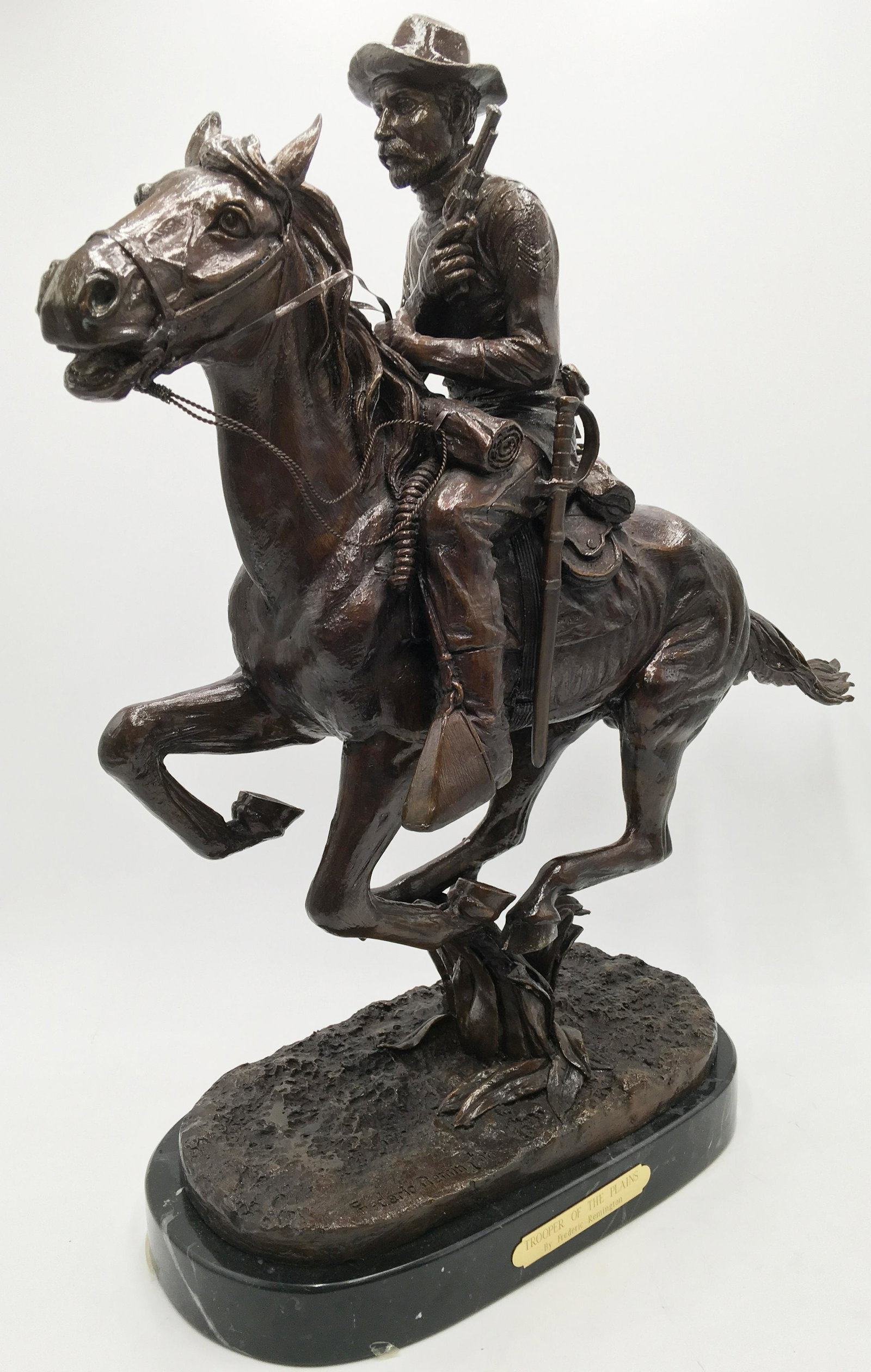 Bronze Frederic Remington Sculpture.: Titled "Trooper of the Plains". On a Marble Base. Measures 22" Tall. This Sculpture has a Shiny Brown Painted Coating over the Bronze Metal. Third-Party Shipping Required.
