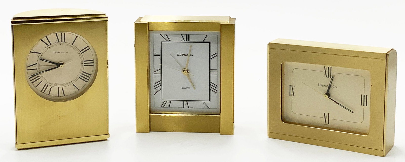 Lot of 3 Brass Desk Clocks - 2 are Tiffany & Co.: The Third Clock is C.D. Peacock. All Three are Swiss Made, and are Very Heavy. They are not Currently Running - They Probably just need Batteries (Pretty Small Batteries at that). They have Light Scra
