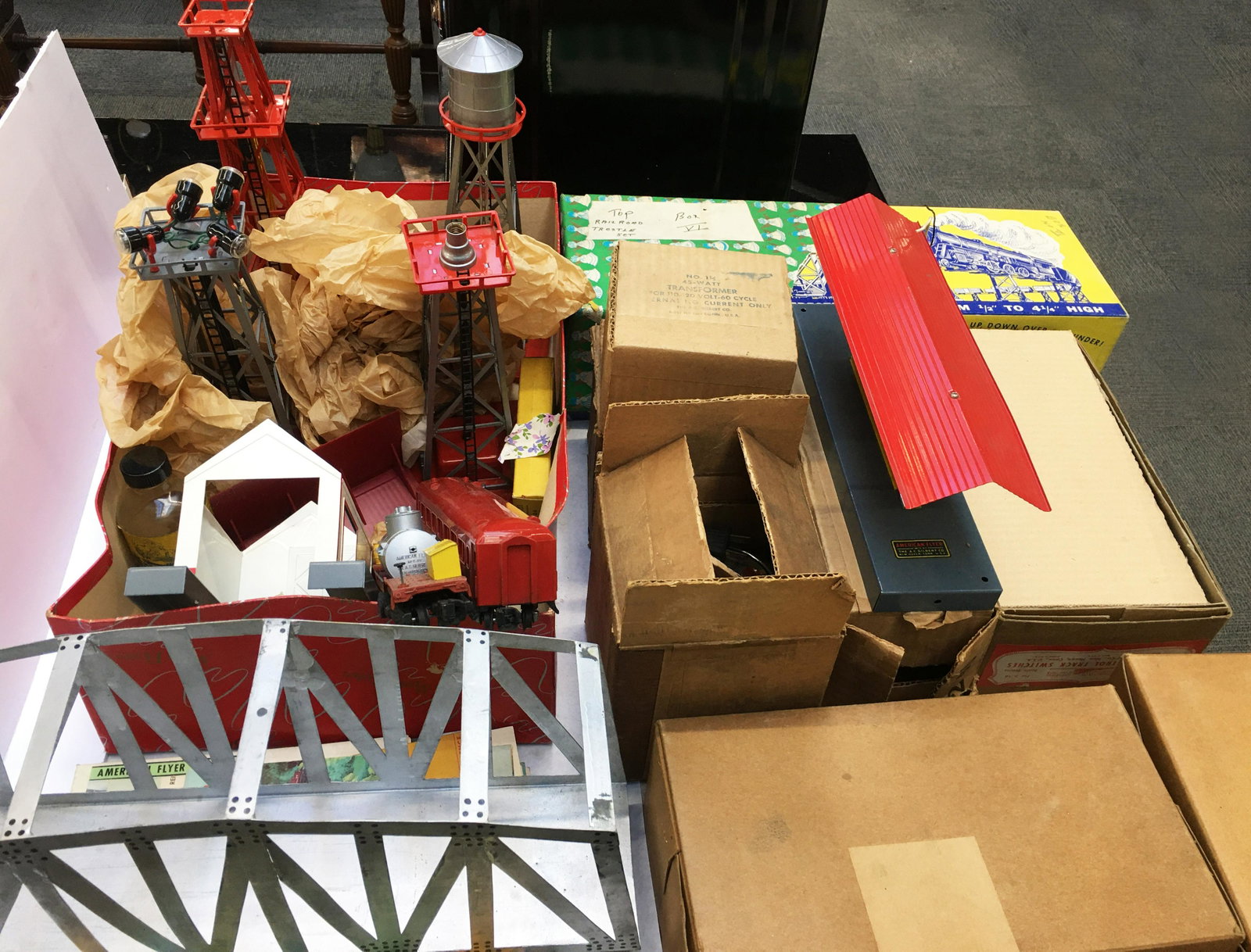 Lot of American Flyer Towers, Cars, Etc.: Includes: A Bridge (Probably Hand-Made), American Flyer Pamphlets, Colber Tank Tower, 3 American Flyer Towers (2 with Lights), #948 Service Car, #650 Passenger Car, Tool Shed, Lighted Passenger Statio