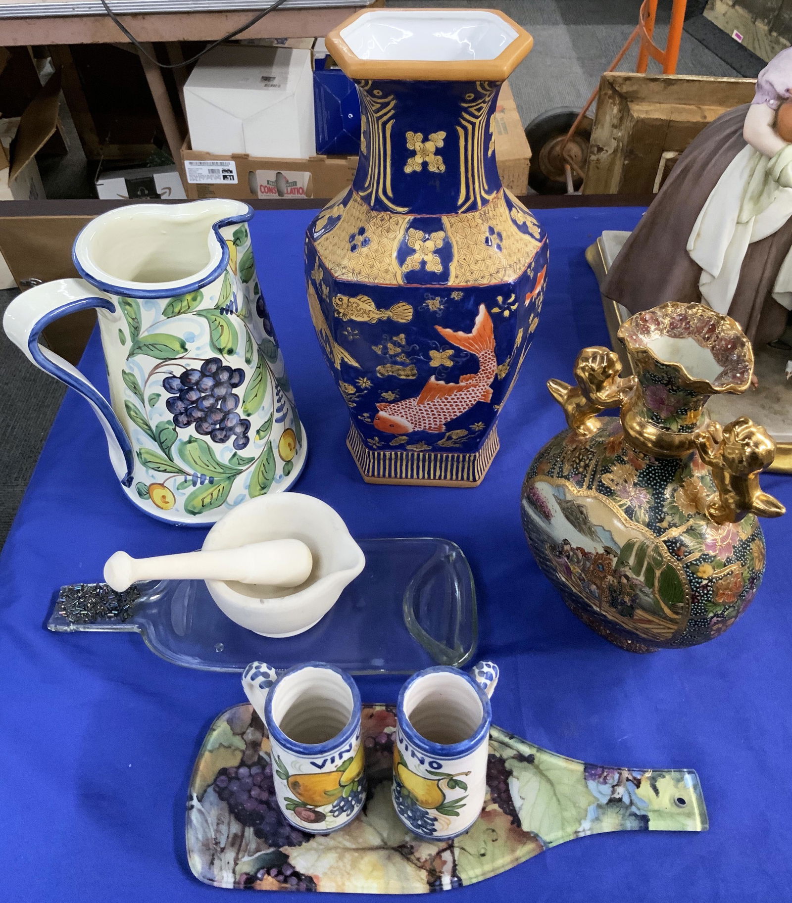 Lot: Mostly Porcelain Pieces.: A Tall Chinese Vase with Fish Design (14 1/2" Tall), a Gold Adorned Chinese Vase, 3 Fruit Design Porcelain Pieces, a Bisque Mortar & Pestel, and Two Glass Wine-Bottle Shaped Trays. Third-Party Shippin