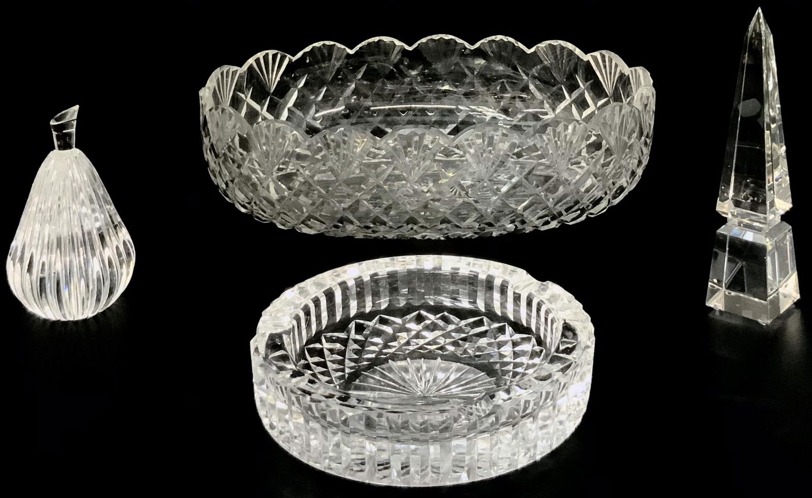 Lot: 3 Pcs. Waterford Crystal & Swarovski Obelisk.: A Signed Waterford Crystal Pear (4 3/8" Tall), a Swarovski Obelisk (6 1/2" Tall), A Waterford Crystal Ashtray), and a Waterford Bowl ( 10 3/4" Wide, 3 1/2" Tall). Third-Party Shipping Required.
