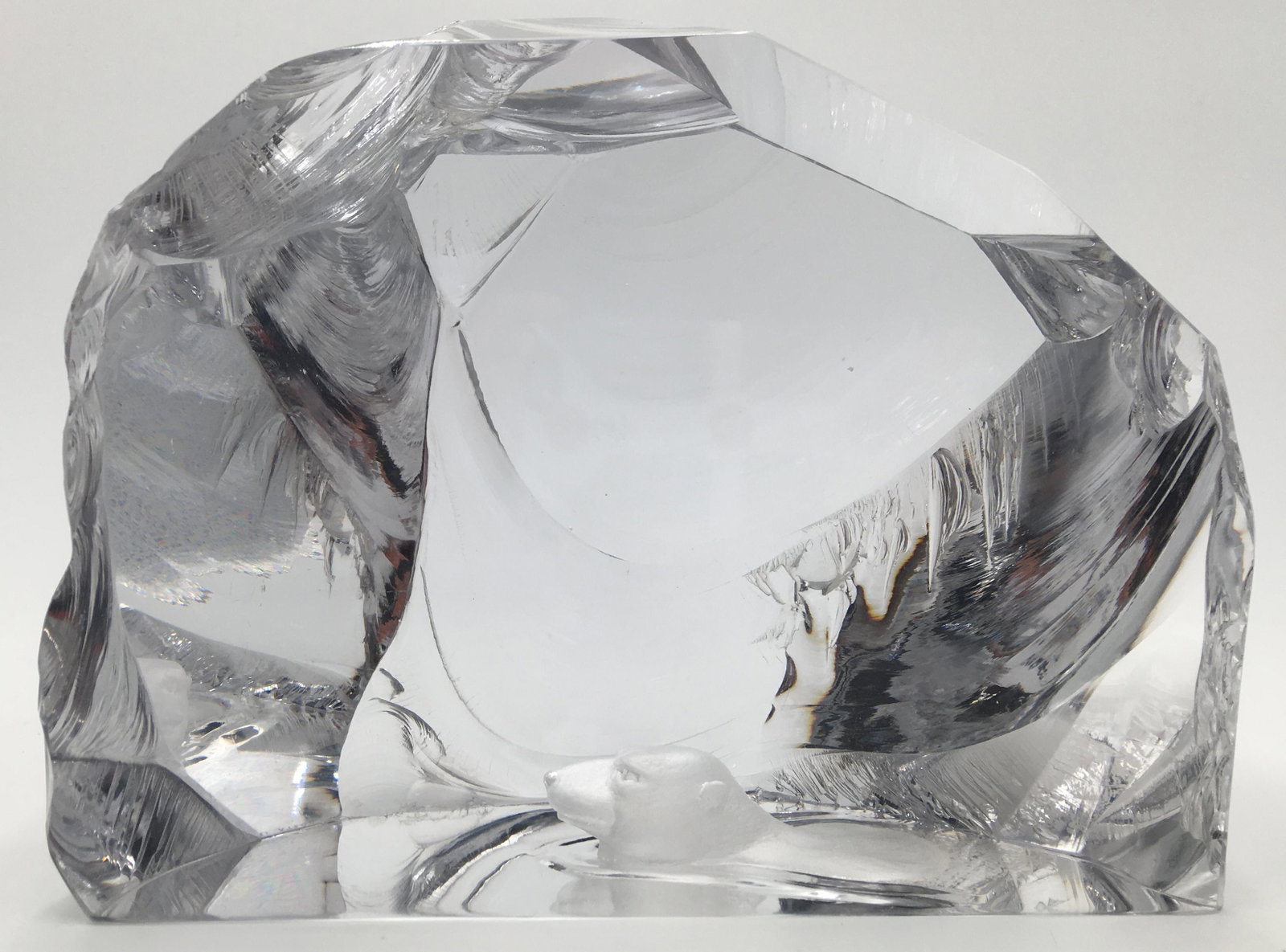 Sgd. Kosta Lindstrand Glass Sculpture w/Polar Bear: The Polar Bear is inside the Sculpture when you Look Into It. May Possibly have a Little Damage on the Piece on the Top, or, Perhaps that is How it is Made. Signed Underneath. Measures 7 1/2" Tall and