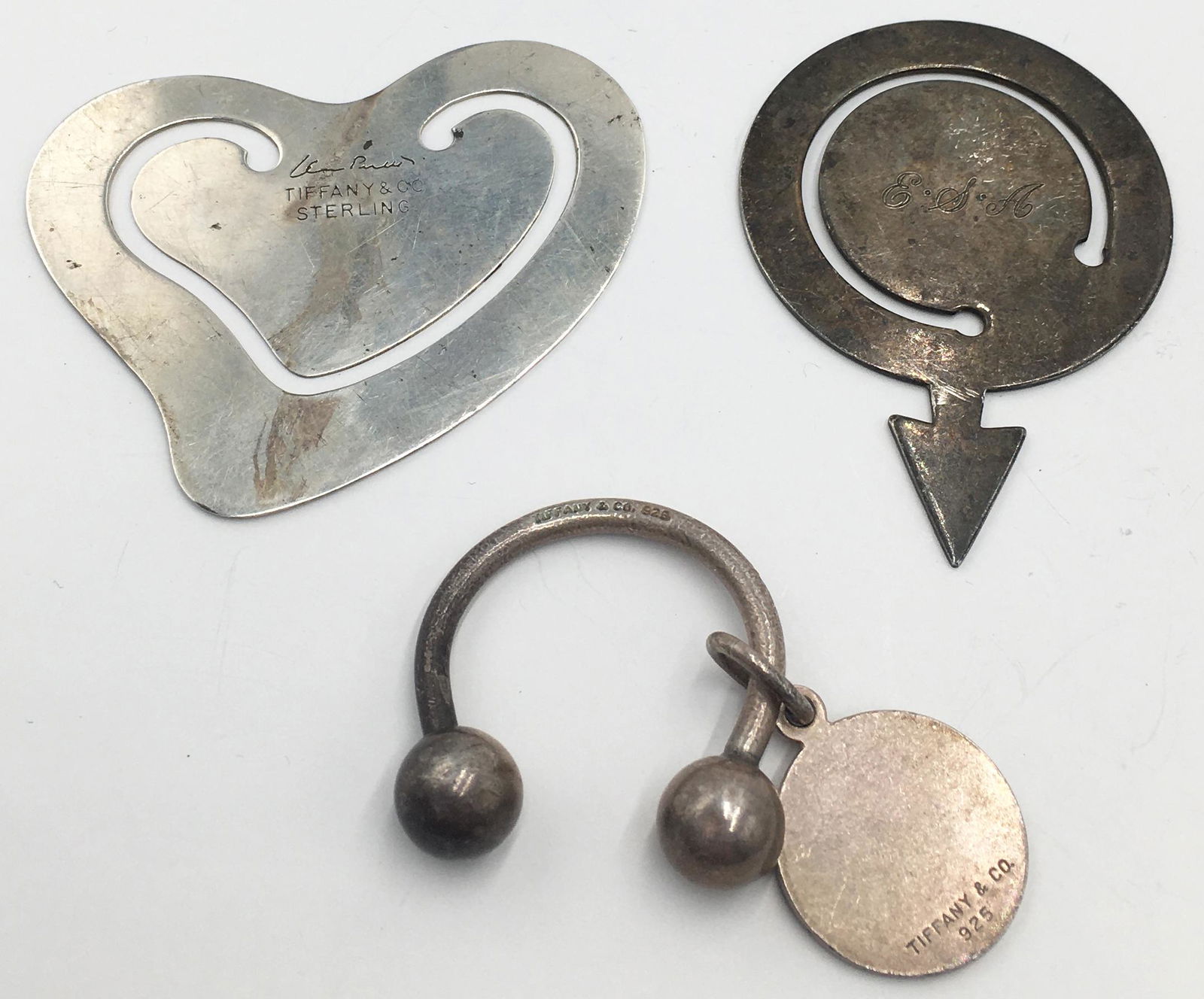 Lot: 2 Tiffany & Co. Bookmarks, and Keychain.: All Pieces are Sterling Silver. Both of the Bookmarks are Monogrammed. One of the Bookmarks is Signed Elsa Peretti. All Three Pieces are Tarnished, to One Degree or Another. The Arrow Bookmark Measure