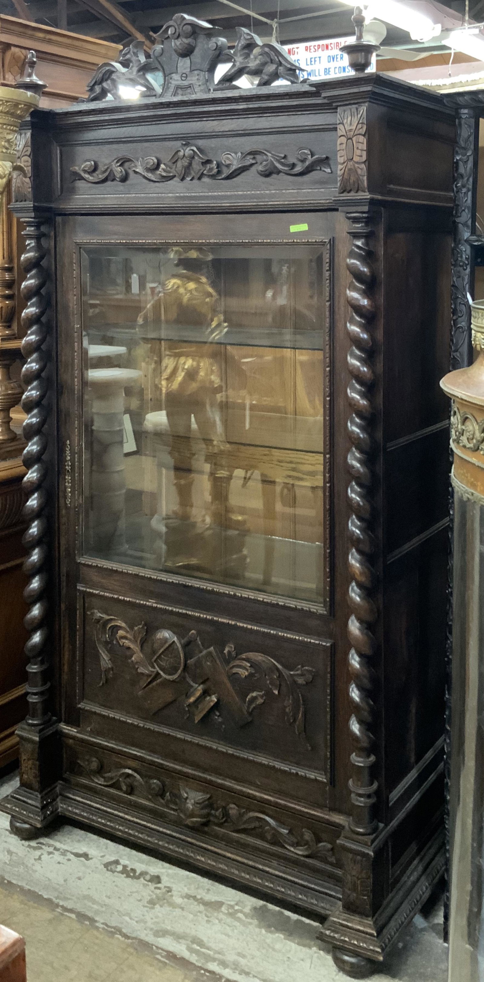 19th Century Masonic Oak Display Cabinet.: With Barley-Twist Sides, a Bevelled Glass Door, and a Drawer on the Bottom. The Cabinet Measures 39 3/8" Wide, 79" Tall, and 21" Deep. Each Side has One Cracked Panel. The Cabinet would Still be Consi