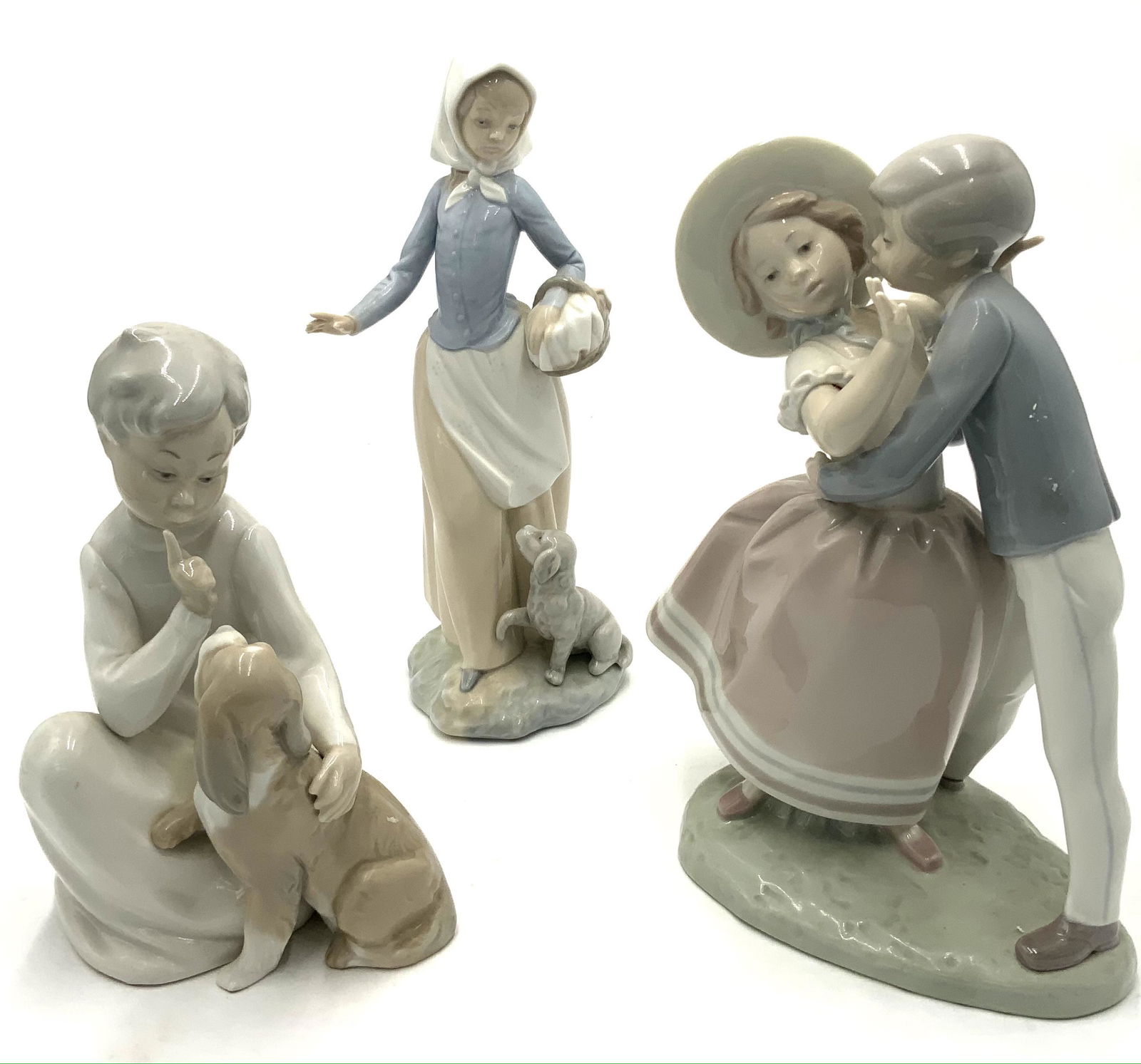 Lot of 3 Figurines - 2 Lladros, 1 Zaphir.: The Girl with the Dog is the Zaphir. The Other Two are Lladros. The Tallest Figurine Measures 10 1/2" Tall. Third-Party Shipping Required.