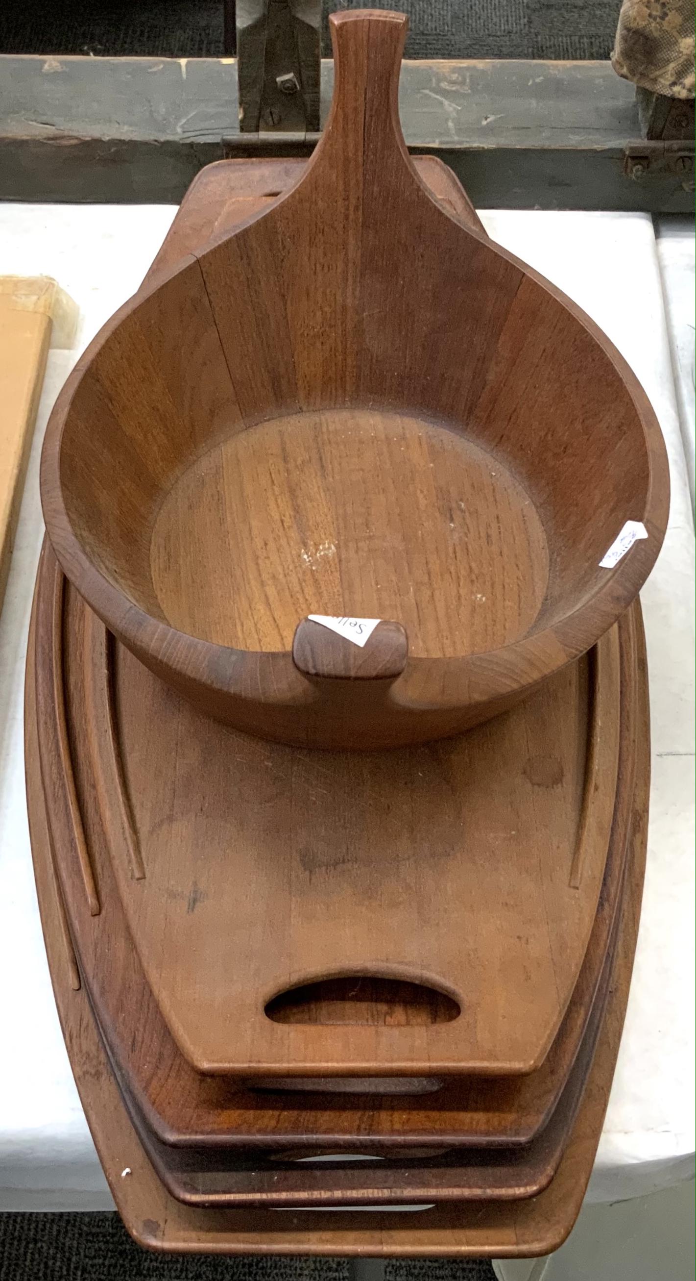 Lot: 4 Danish Modern Teak Trays and One Bowl.: Mid-Century Modern. 3 Trays and the Bowl are all Marked "Staved Teak - Denmark". The Other Tray is Marked "Dansk Designs - Denmark". The Largest Tray Measures 26 3/4" Long. All Trays have Water Marks,