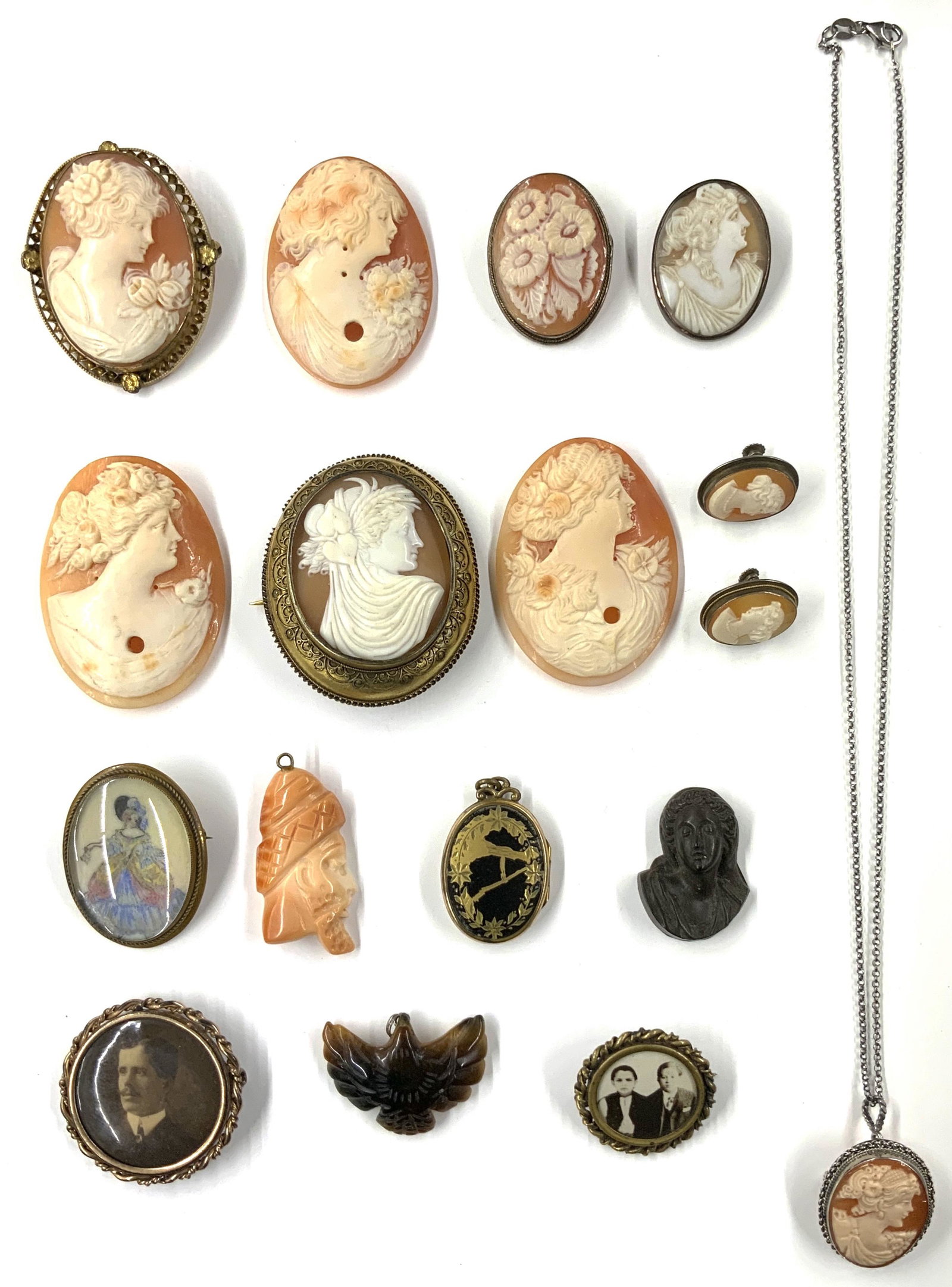 Lot of Cameo Pins, Earrings & Miscellanous.: Three of the Cameos have Holes in them. Also Included is a Carved Coral Pendant, Stone Eagle, a Locket and Two Antique Photo Pins. There is a Few Silver Items Here. The Largest Cameo Pin Measures 2 1/