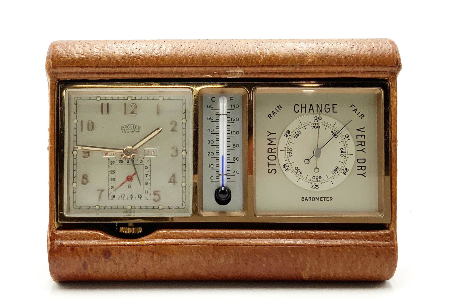 Vintage Angelus 8 Day Travel Clock w/Day-Date.: Also, with Thermometer and Barometer. Measures 4 1/4" Tall and 5 5/8" Wide. Working Condition is not Known. Receipt Shows it was Last Serviced in 1977.