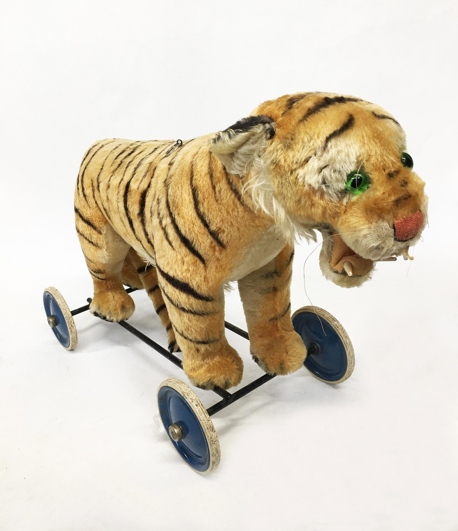 Vintage Stuffed Tiger Pull Toy.: With Glass Eyes. Missing One Tooth. Has a Ring in its Back to Attach a String or Rope To in Order to Pull it. Measures 18" Tall and 29" Wide. Third-Party Shipping Required.