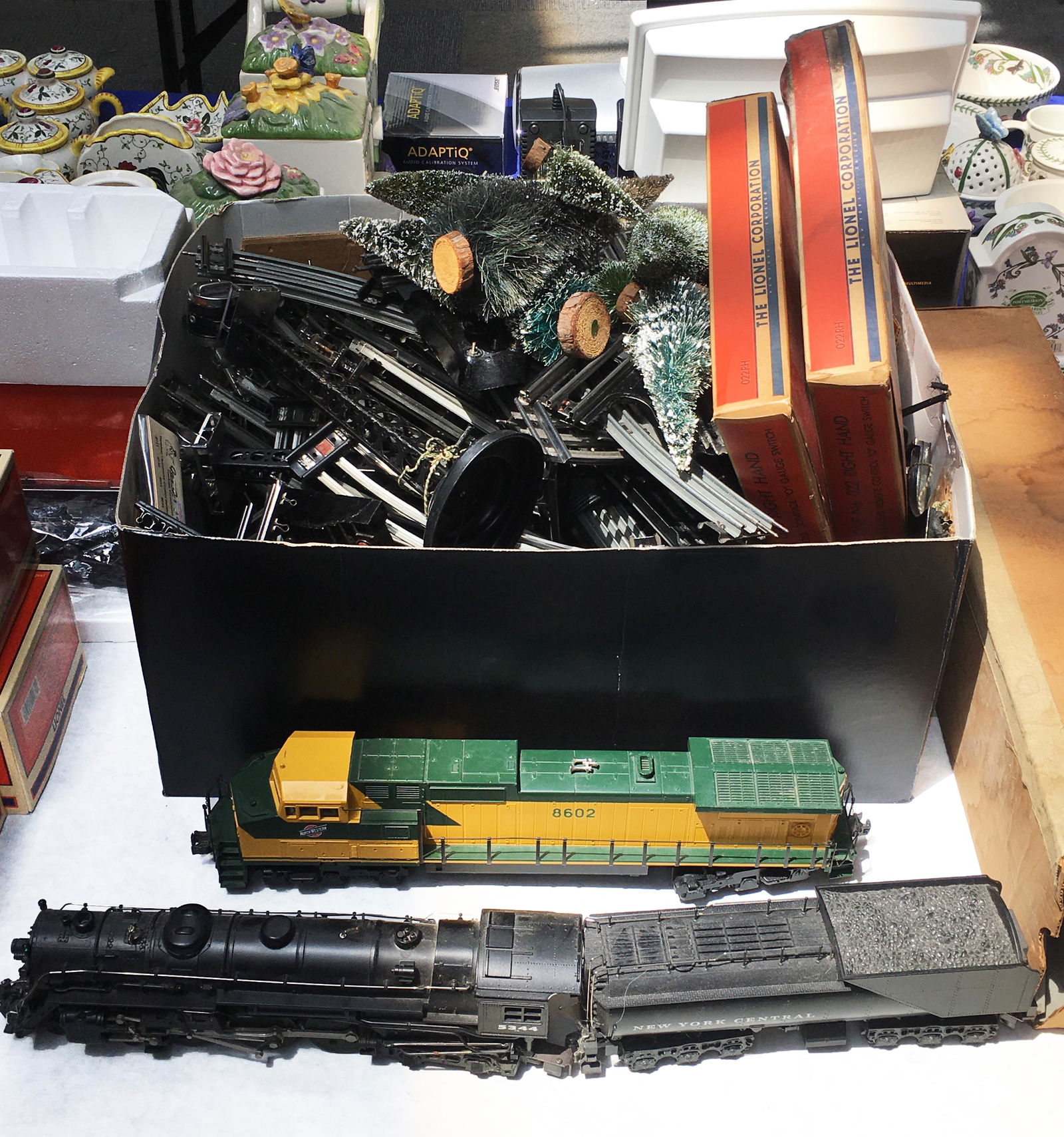 Lot w/Lionel Train Engines, Track, Spotlights, etc: Includes: an 8602 Northwestern Engine, a 5344 New York Central Engine & Tender, a Box of Track & Switches, a Searchlight on a Stand, a Pair of LIghts on a Stand, and a Lionel 763 Box (Box Only). Third