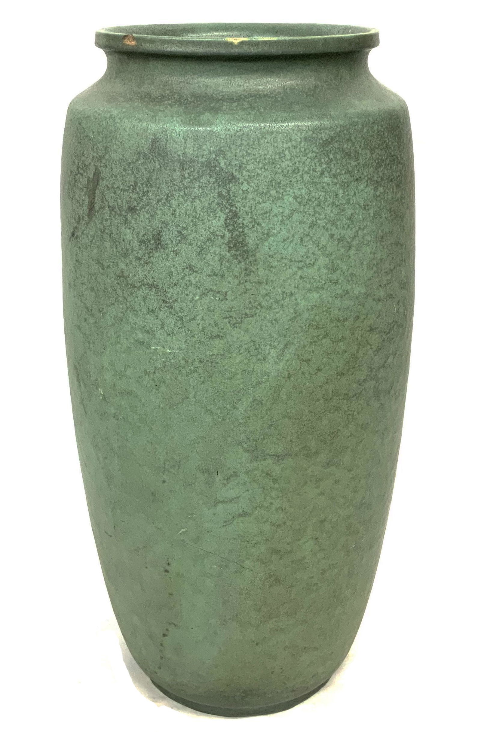Large Teco Garden Vase, As Is.: Double Signed on the Bottom. Measures 27" Tall and 12 3/4" in Diameter. Has a Large Chip on the Rim, a Couple of Small Chips on the Rim, and a Little Wear on the Rim. Also, a Little Wear on the Body o