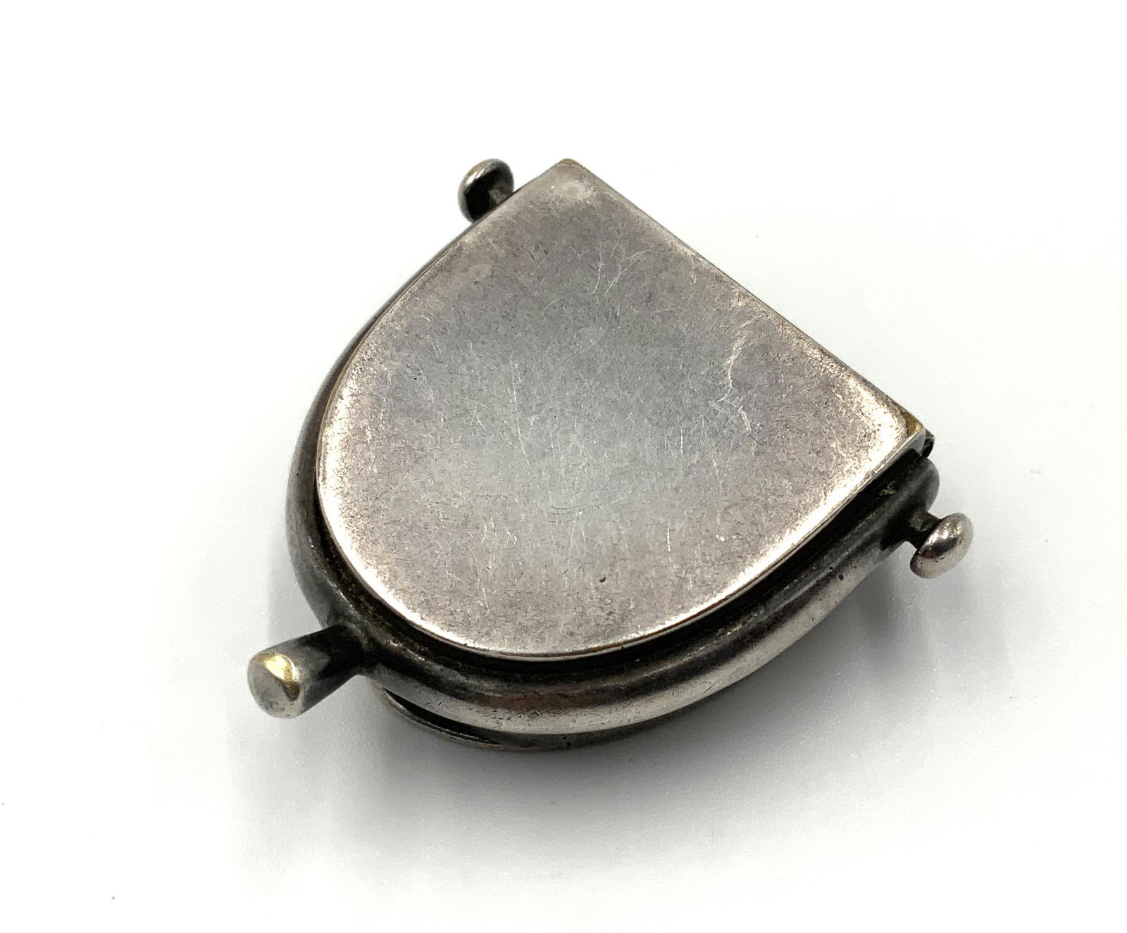 Signed Hermes Antique Pill Box.: Measures 1 3/8" x 1 3/8". We believe it to be Silverplate, but we're not Sure. There is some Wear and a Copper-Like Color Showing from the Lid Latch.