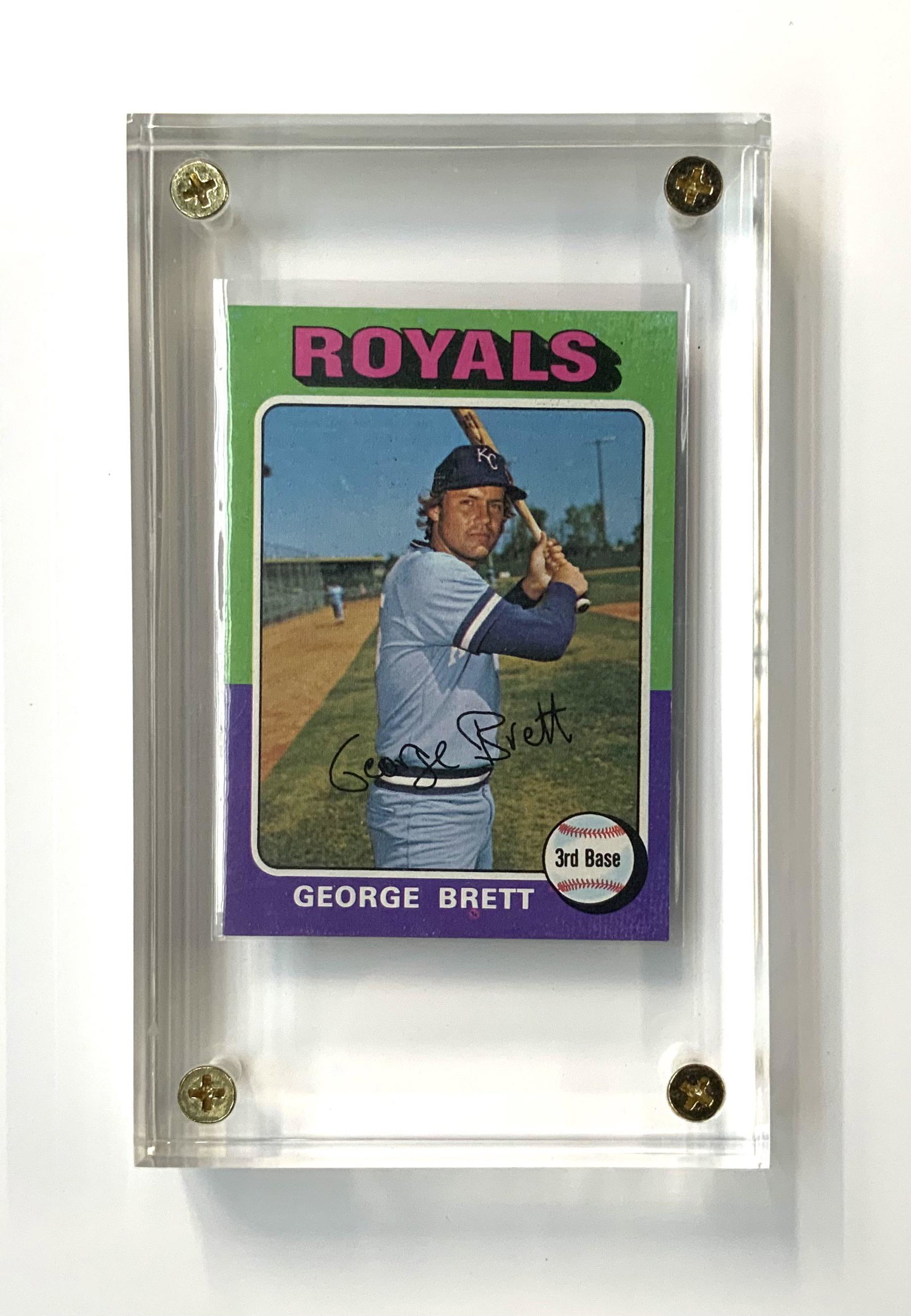 George Brett Rookie Baseball Card, Topps #228.: A 1975 RC (Rookie Card). In Very Nice Condition, all Corners Look Sharp, in a Lucite Case. Ungraded.