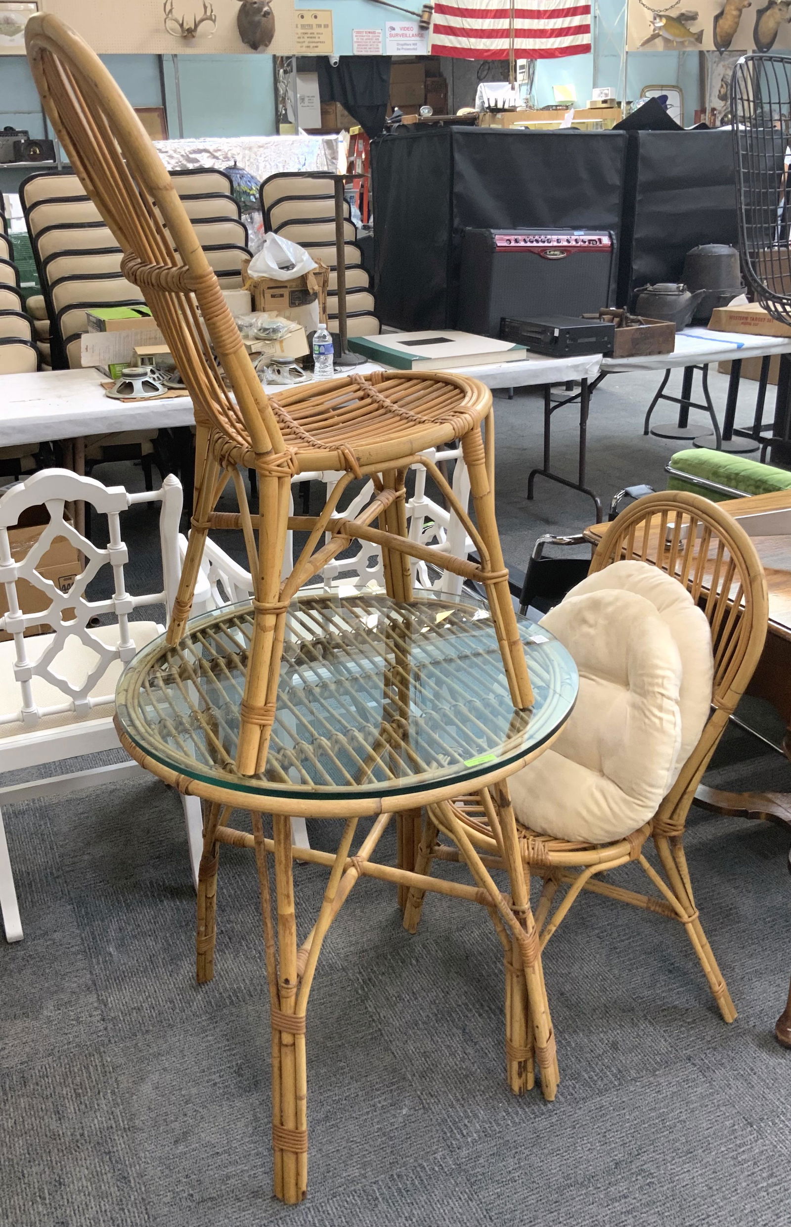 Rattan Round Cafe Table and 2 Rattan Chairs.: The Table has a Glass Top. The Table Measures 28 1/2" High, and 28" in Diameter. The Set is in Very Good Overall Condition. Third-Party Freight Shipping or Personal Pickup Required.