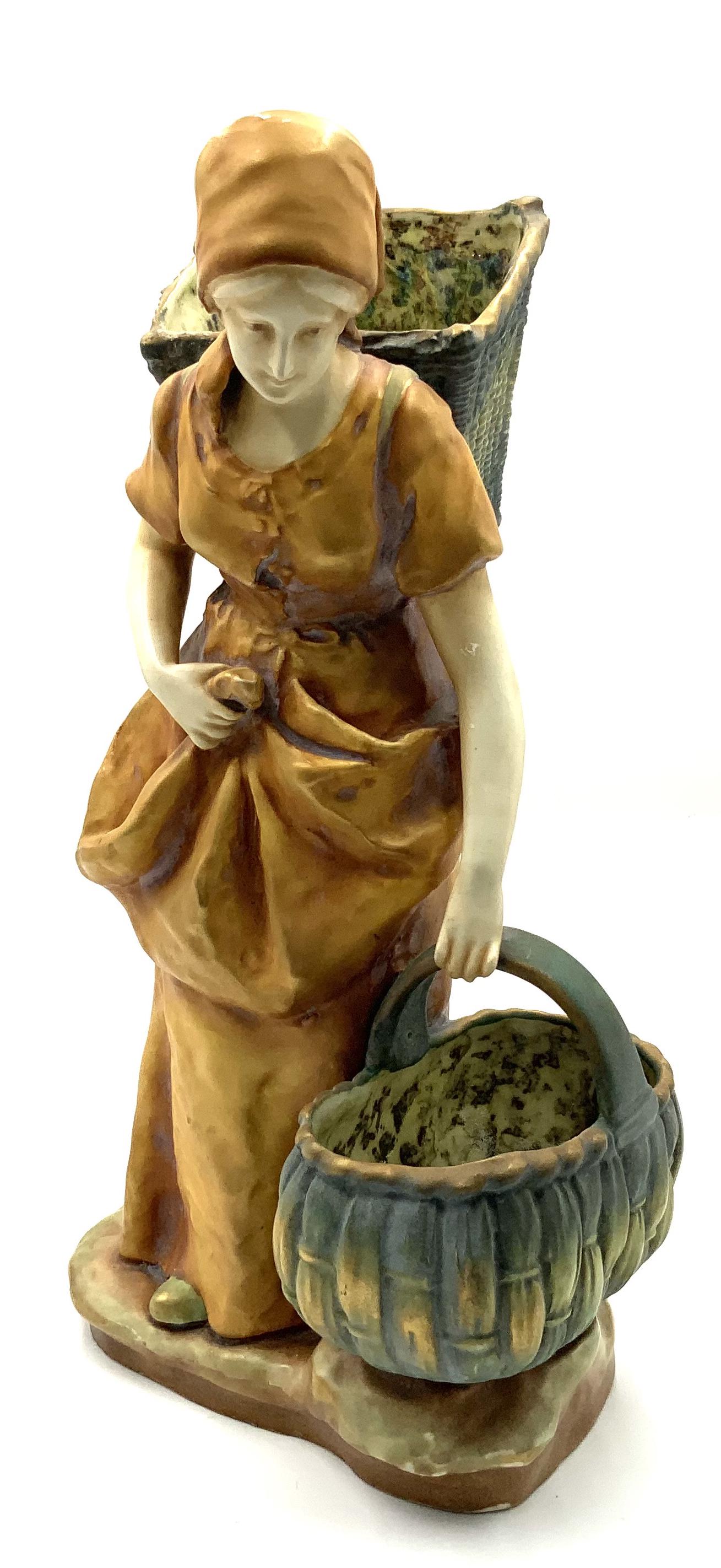 Lg. Amphora Figurine of Peasant Girl with Baskets.: Signed "Amphora" in the Oval Underneath. Measures 16 1/4" Tall. In Good Condition, but has some Crazing. Third-Party Shipping or Personal Pickup Required.