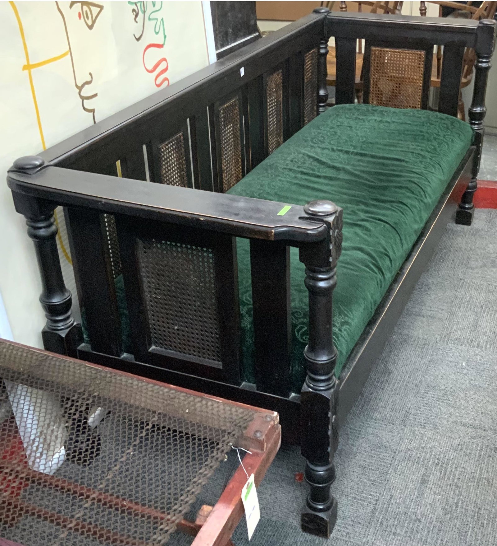 Dark Wood Antique Sofa with Cane Sides.: With a Dark Fabric Cushion Seat. Measures 80" Wide, 33 1/2" Tall, and 29 1/2" Deep. Third-Party Freight Shipping or Personal Pickup Required.