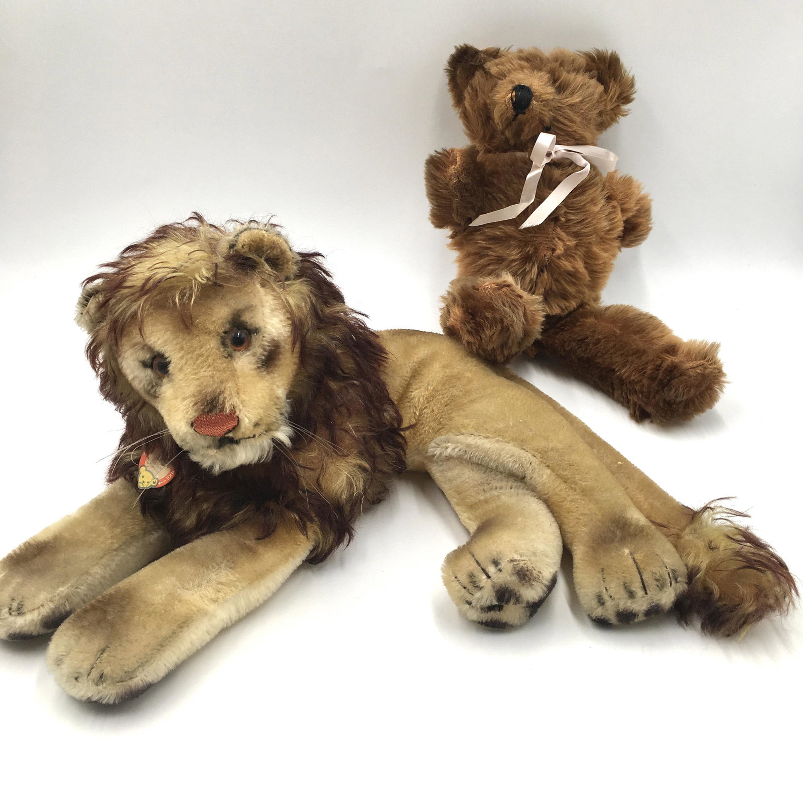 Lot: Steiff Plush Lion and Teddy Bear.: Lion has Steiff tag that says, "Leo". Measures 18" x 13" x 8". Teddy bear has no tag, and is missing its eyes. Measures 15" long.